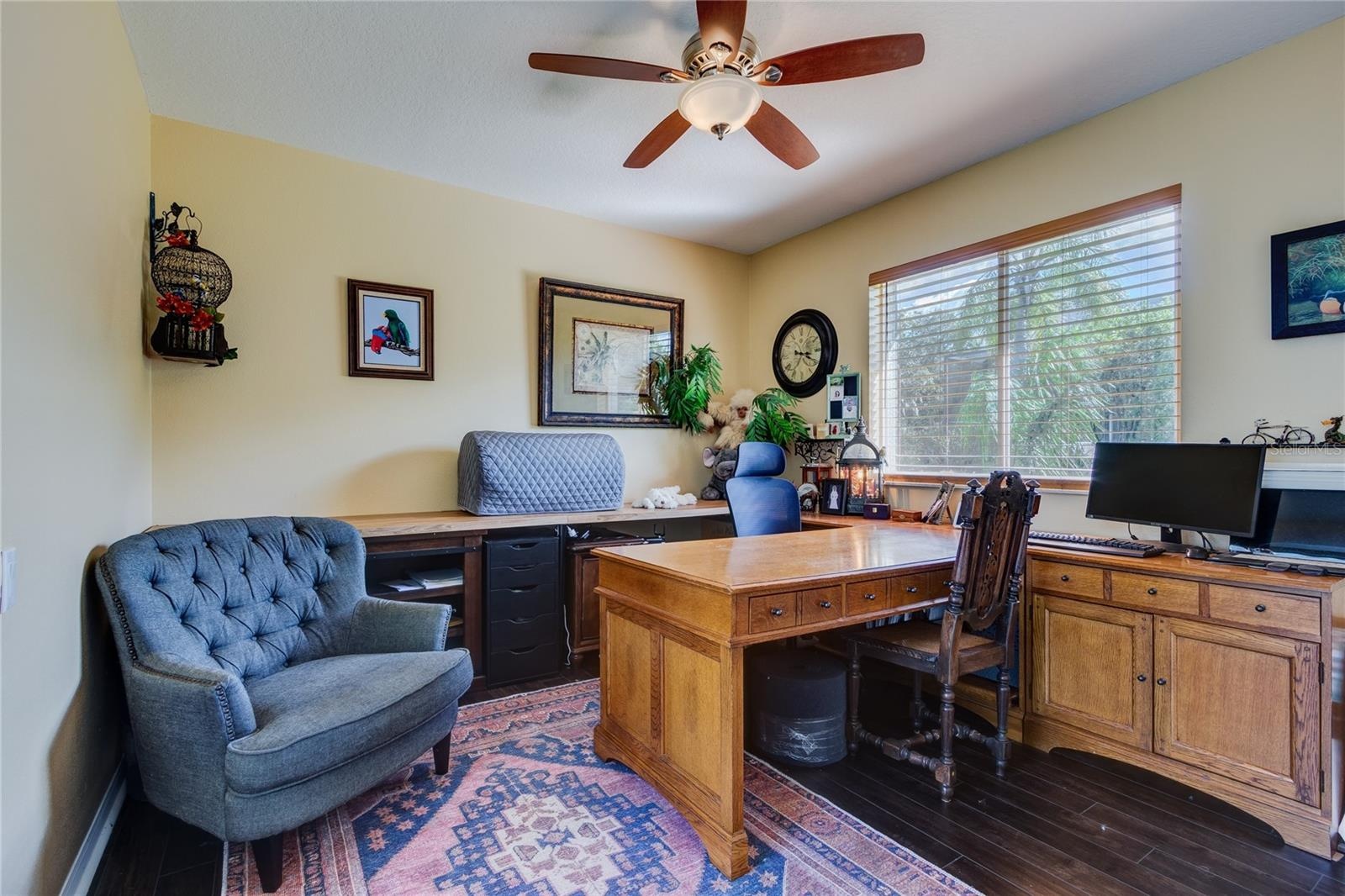 Back bedroom (set up as home office) with double window and sliders to pool area