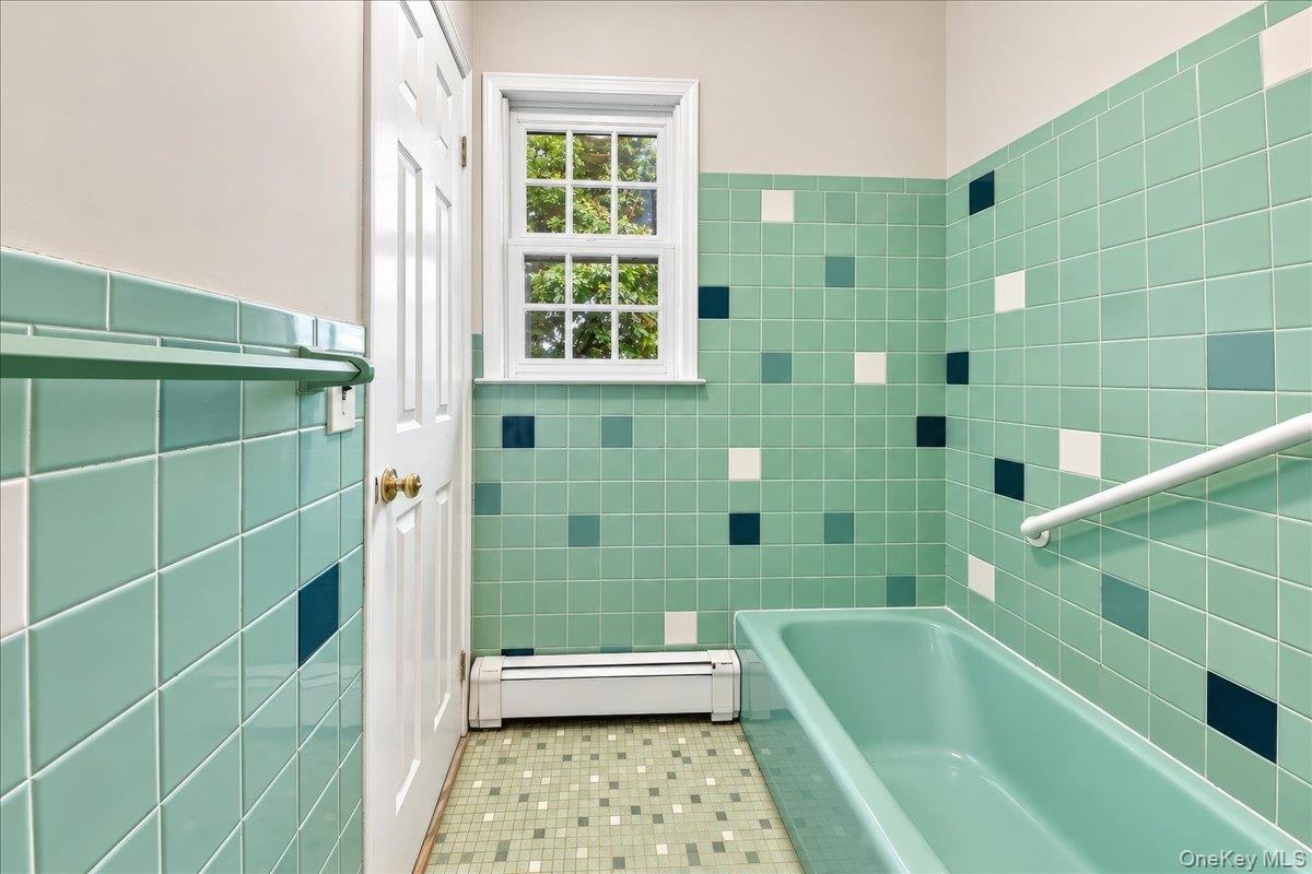 Separate tub area with a private entrance to the primary bedroom, offering added convenience.