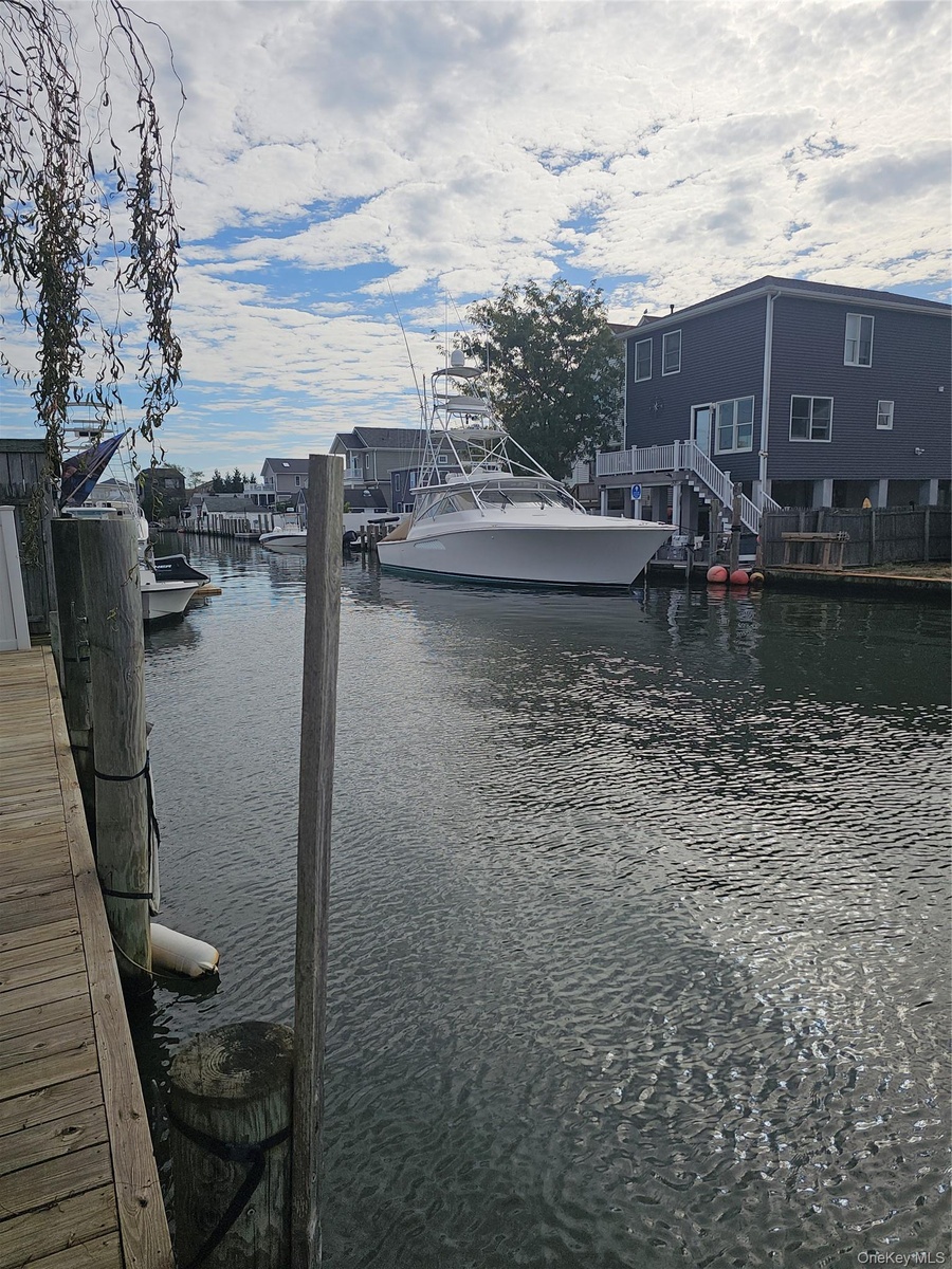 Waterfront property featuring a wood-plank bulkhead and pilings