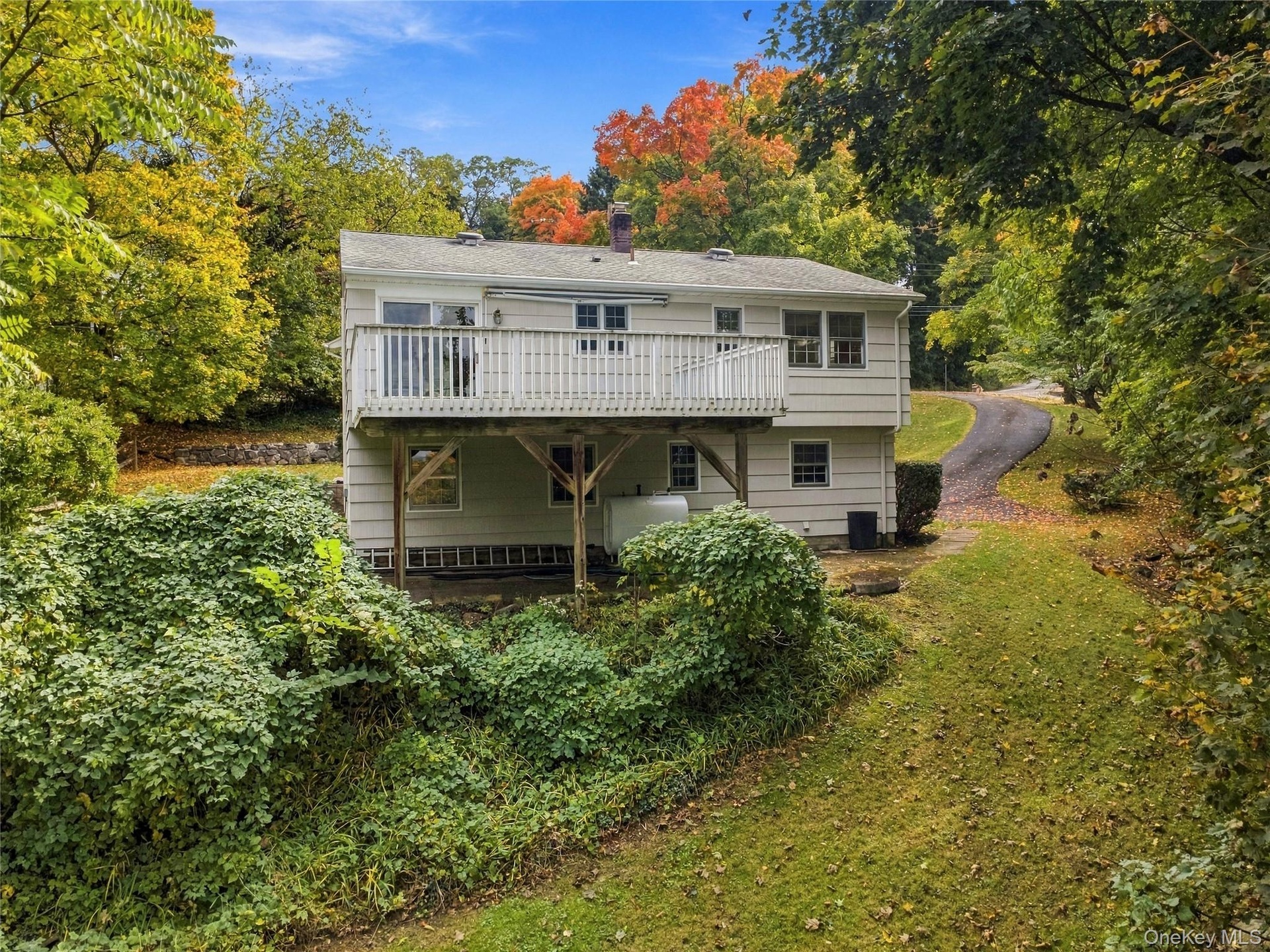 Rear view of the home showcasing the spacious deck, ideal for outdoor enjoyment and entertaining.