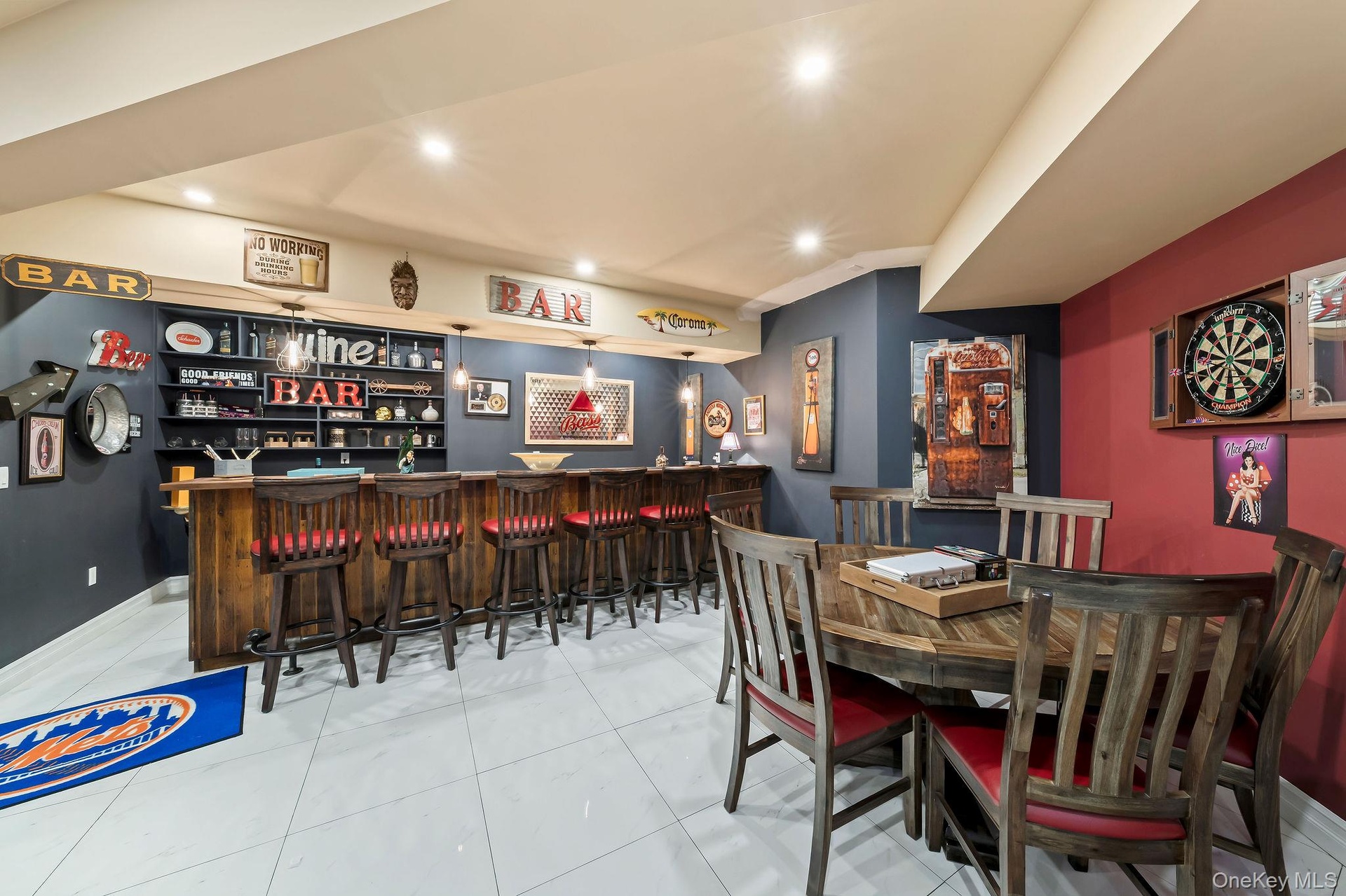 Custom wet bar featuring dark wood-finish cabinetry, recessed lighting, and large-format porcelain tile flooring