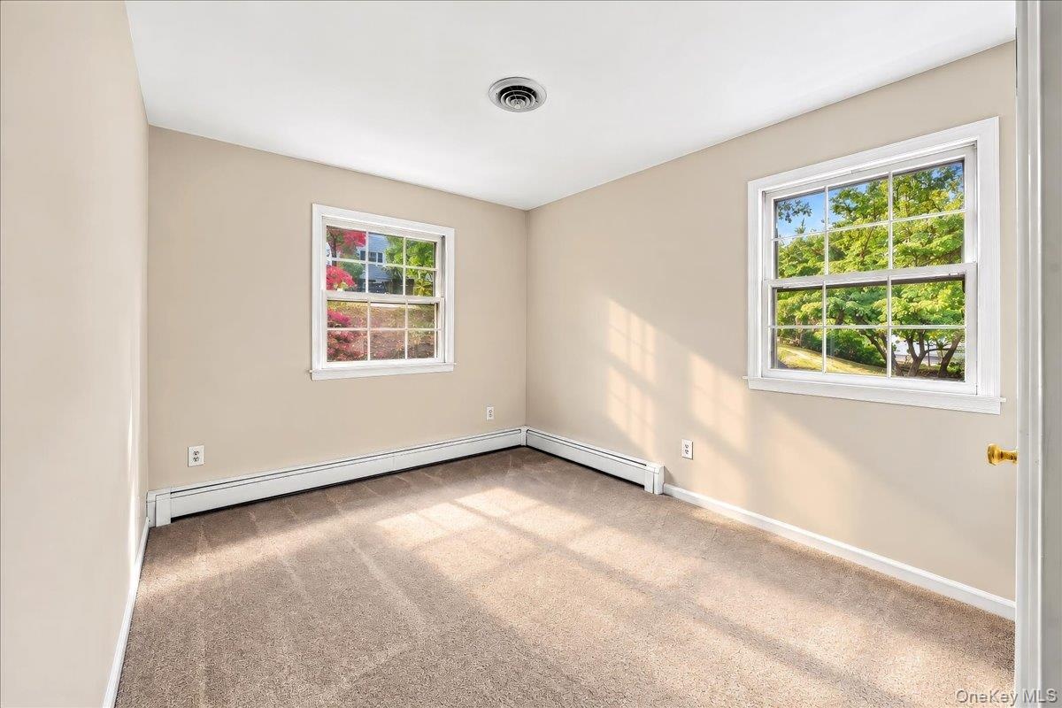 Bright, refreshed bedroom featuring brand-new carpeting and a fresh coat of paint, creating a clean and inviting space.