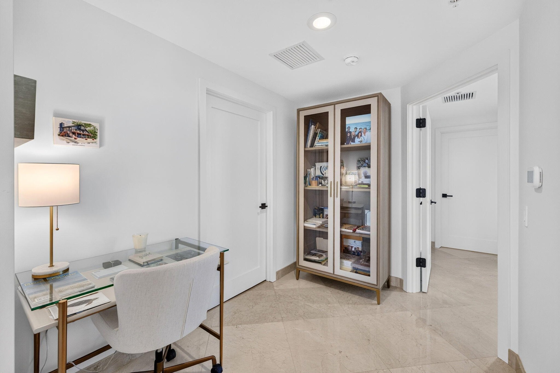 Neutral wall finishes, recessed lighting, and light-toned tile flooring