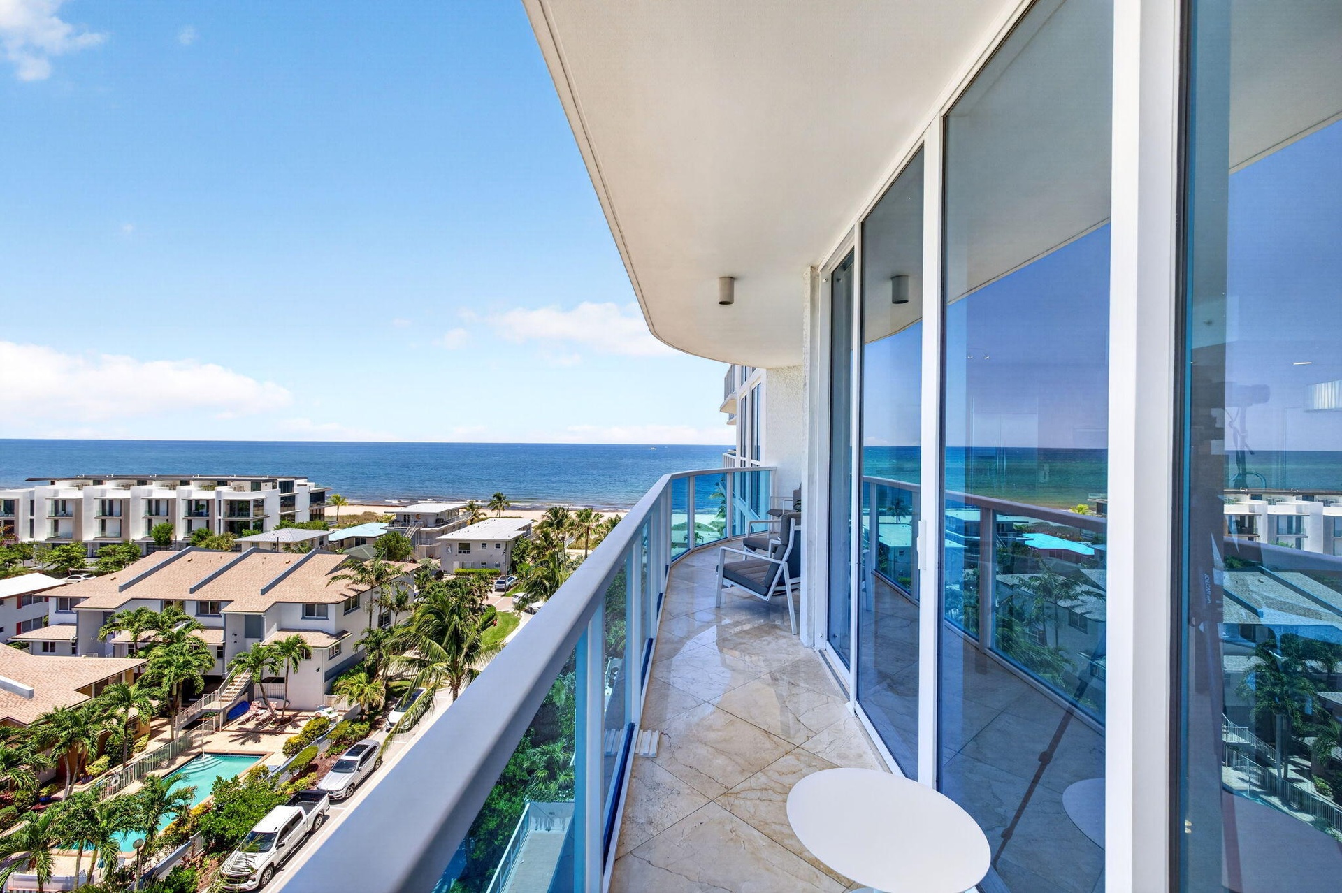 Balcony with glass railings and tile flooring
