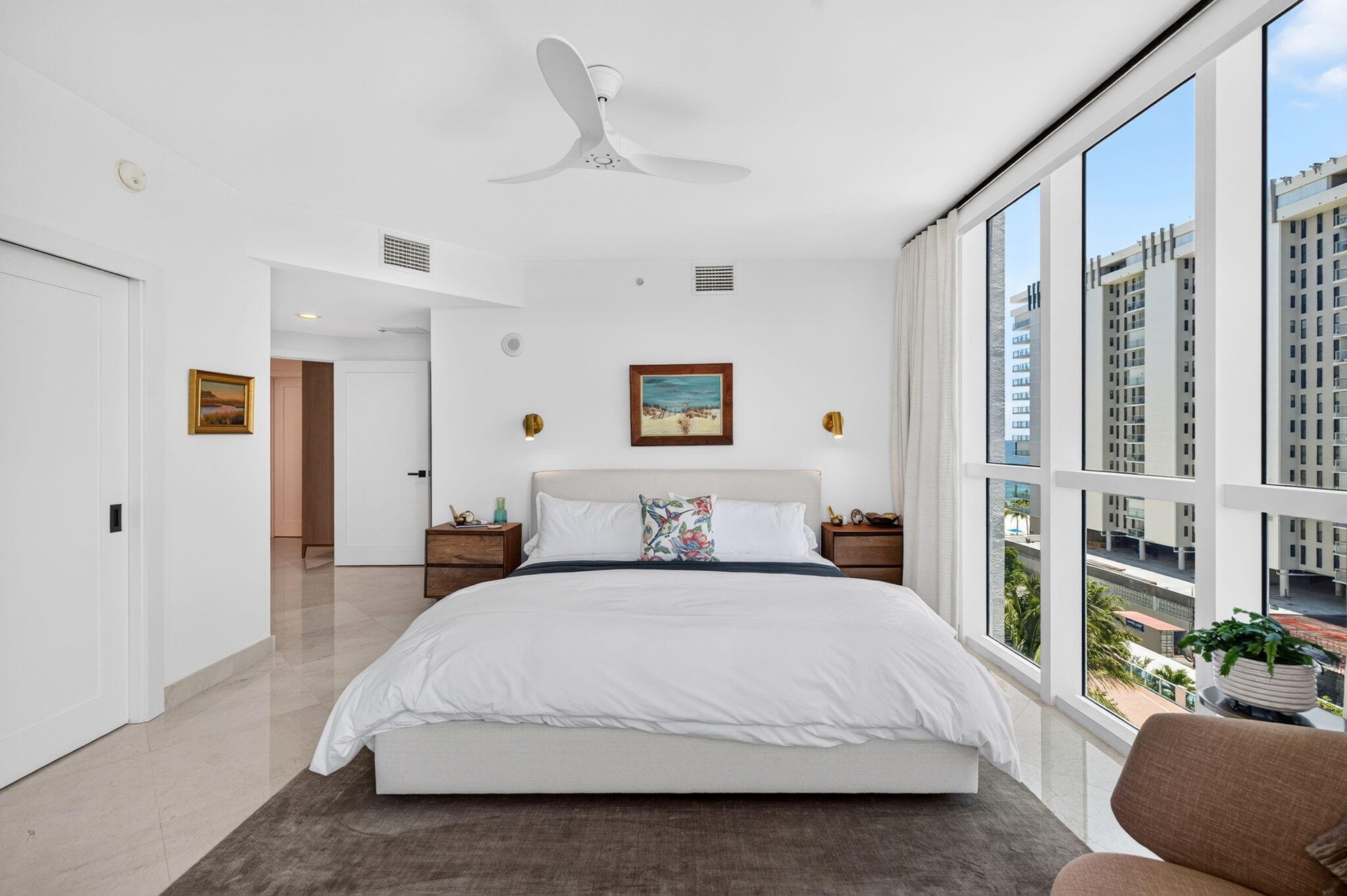 Floor-to-ceiling windows, modern ceiling fan, recessed lighting, and marble flooring