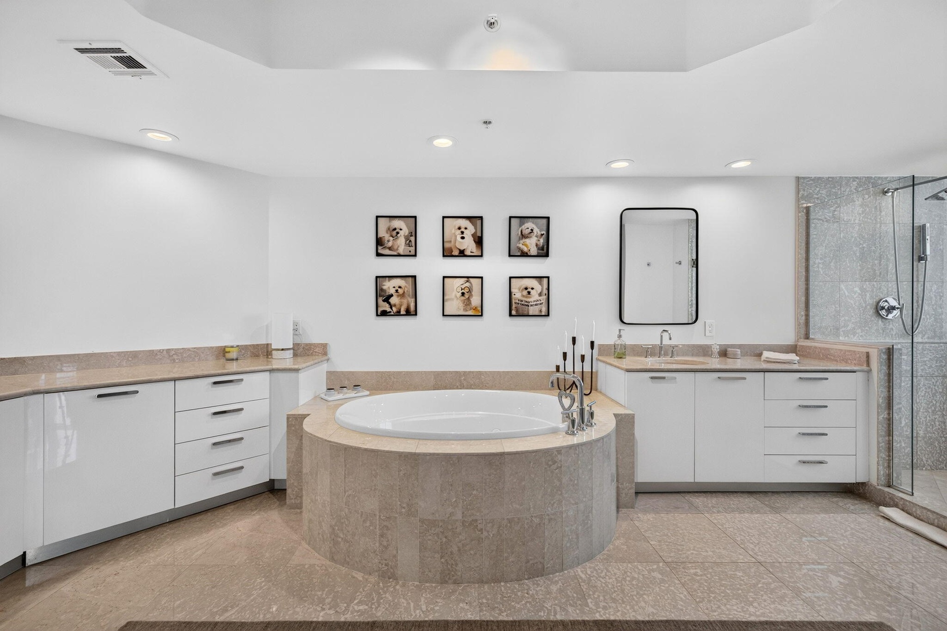 Recessed lighting, a built-in soaking tub with stone surround, a walk-in shower with glass enclosure, white cabinetry, and stone countertops
