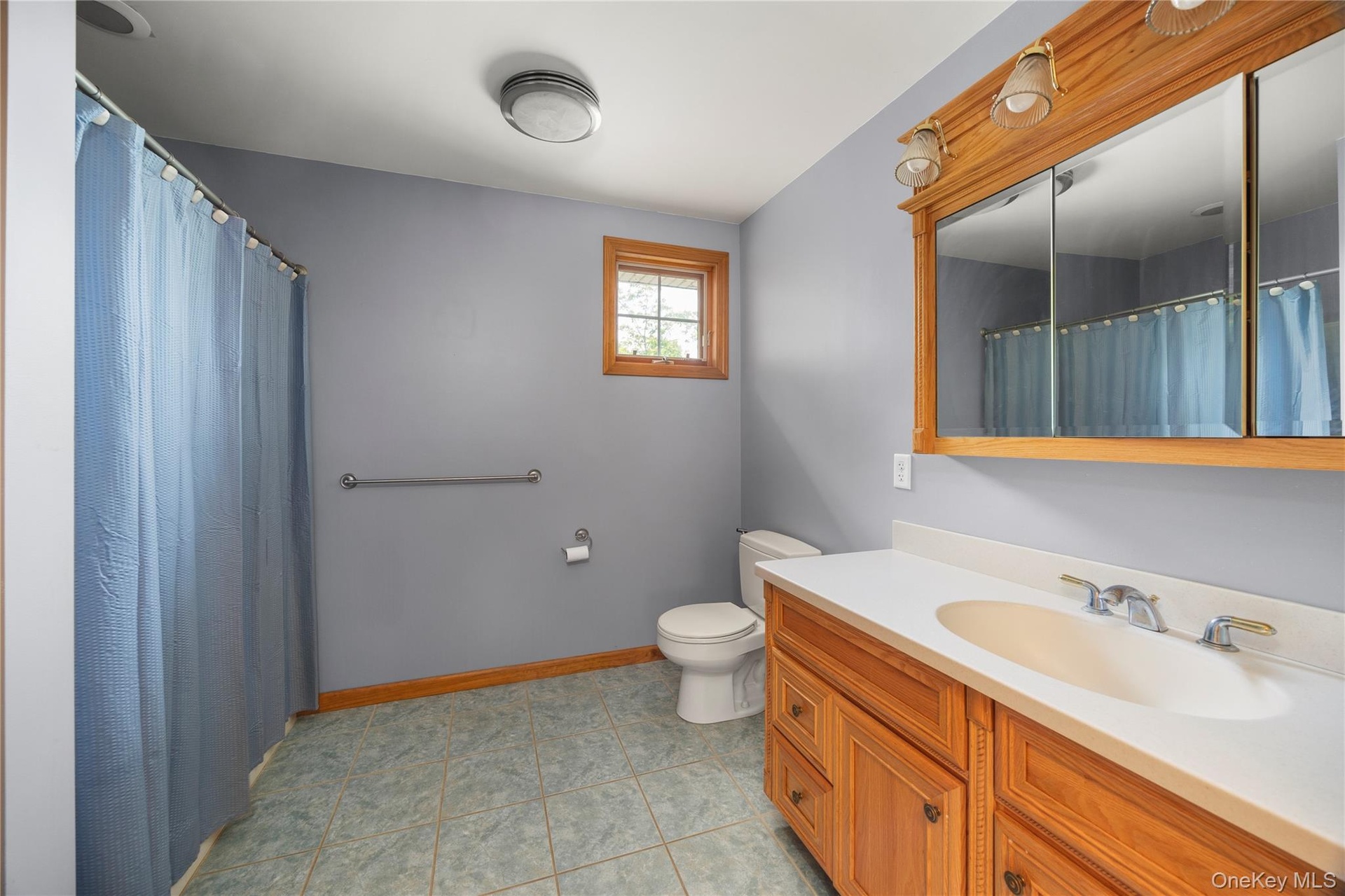 Full bath with vanity and curtained shower