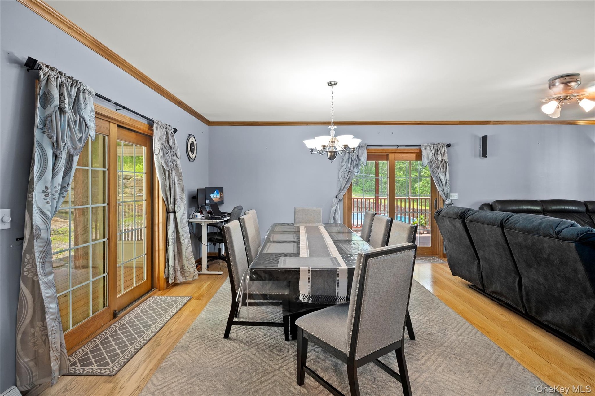 Dining space featuring a chandelier, light wood finished floors, and ornamental molding