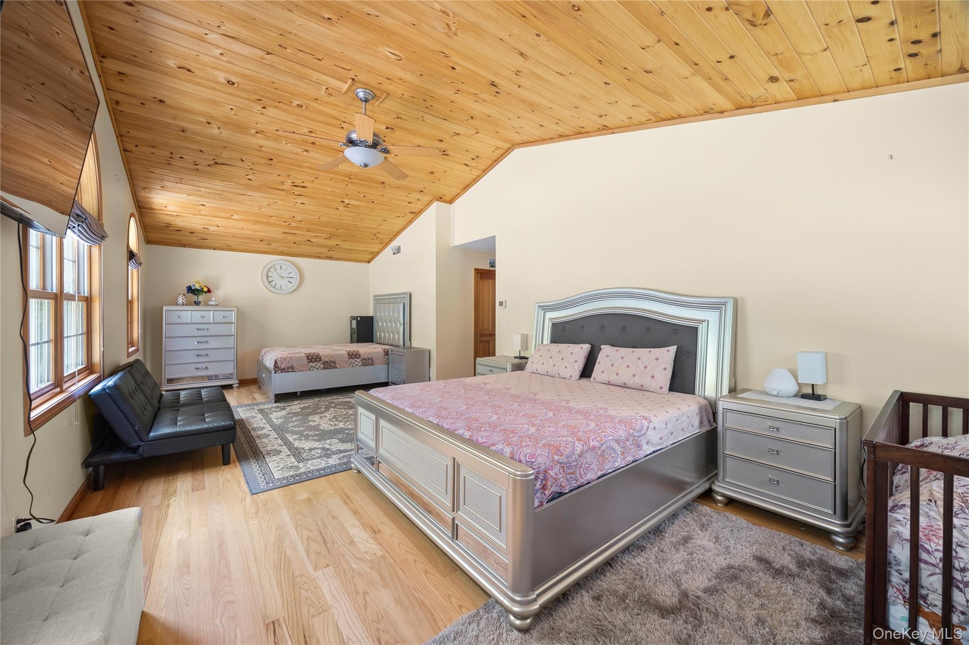 Bedroom with lofted ceiling, wooden ceiling, and light wood-style flooring