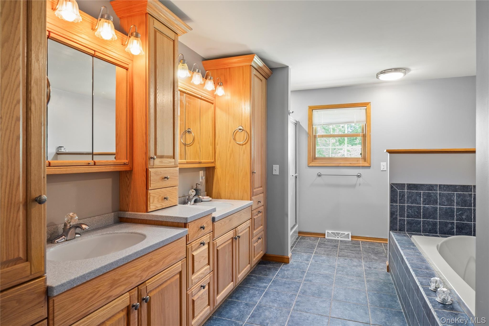 Full bathroom featuring vanity, a bath, and a shower stall