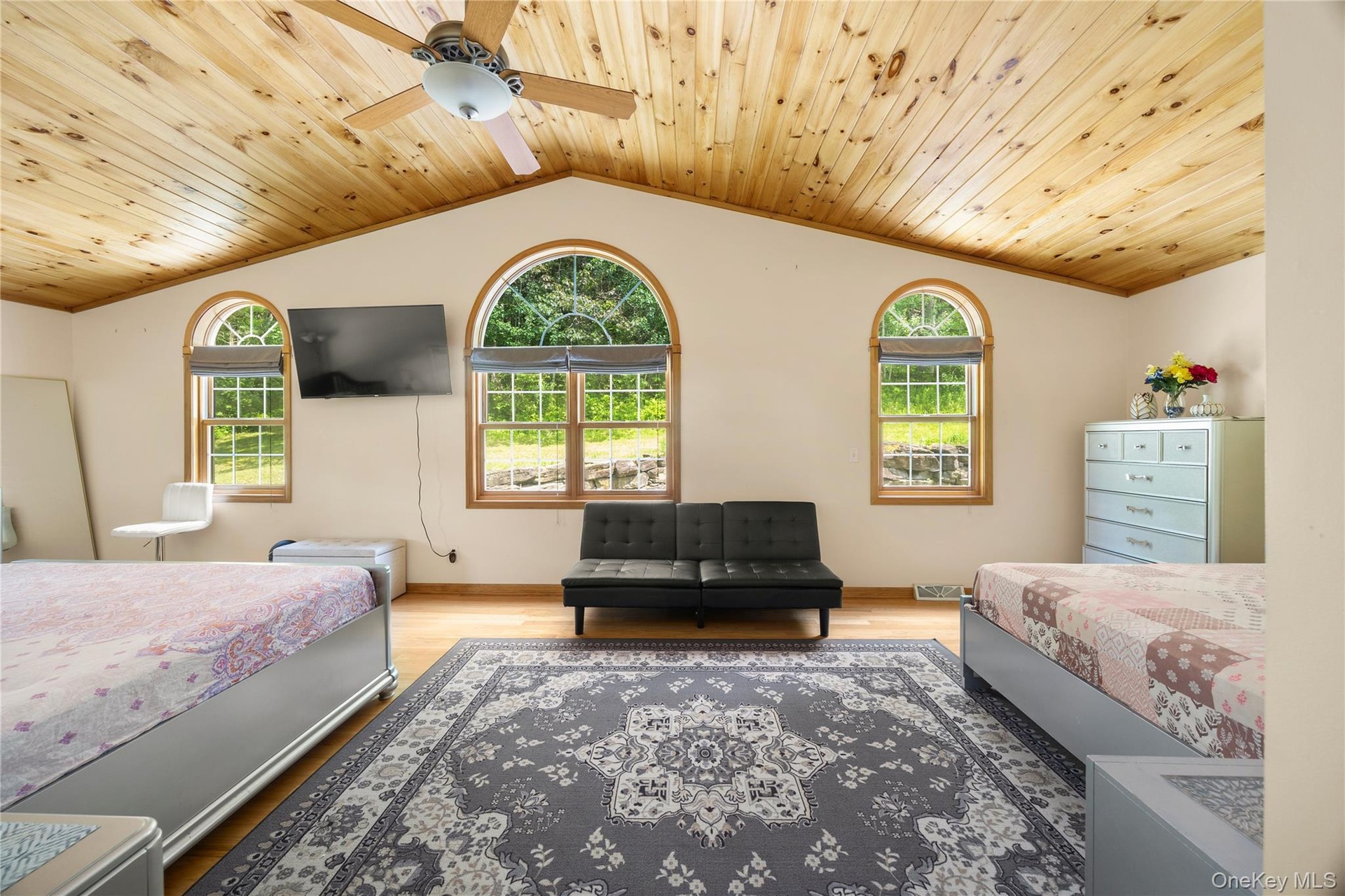 Bedroom with multiple windows, wood finished floors, lofted ceiling, wooden ceiling, and crown molding