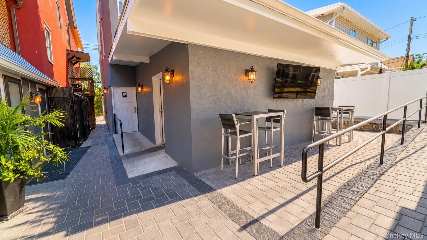 The covered patio offers a versatile outdoor space with convenient access to both the restaurant and private party room. Perfect for entertaining, hos