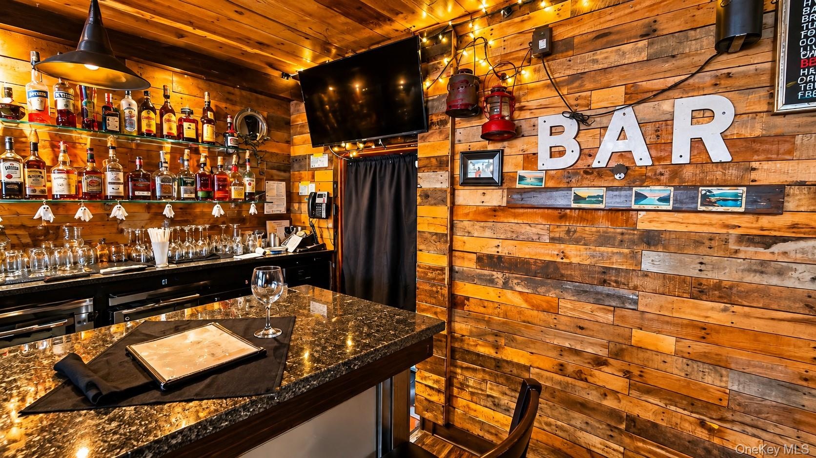 The Tavern’s well-appointed bar offers convenient access to the spacious back patio, making it easy to serve food and drinks to outdoor diners. This t