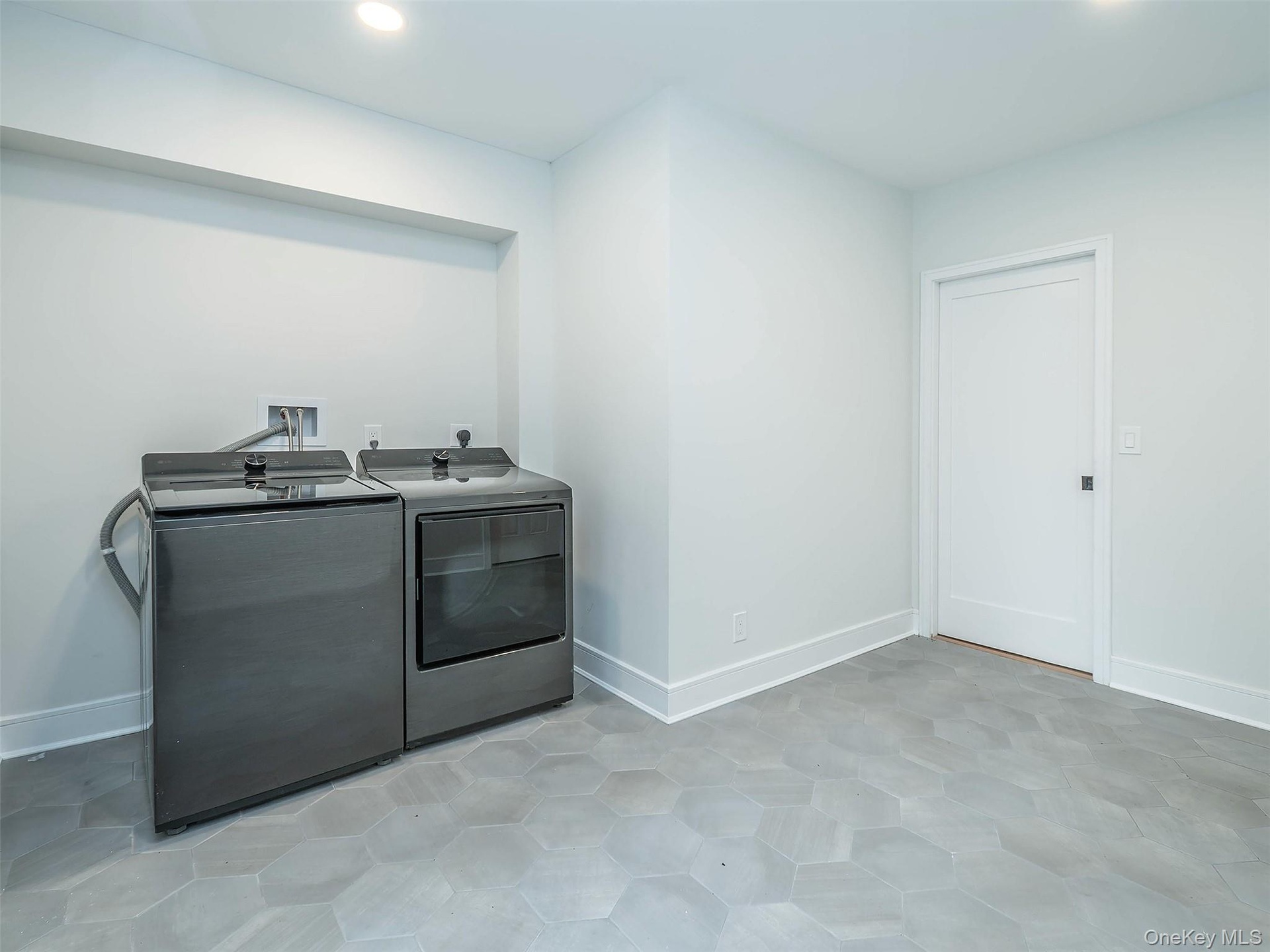 1st Floor: Large laundry room, with plenty of space for the room to multi task!