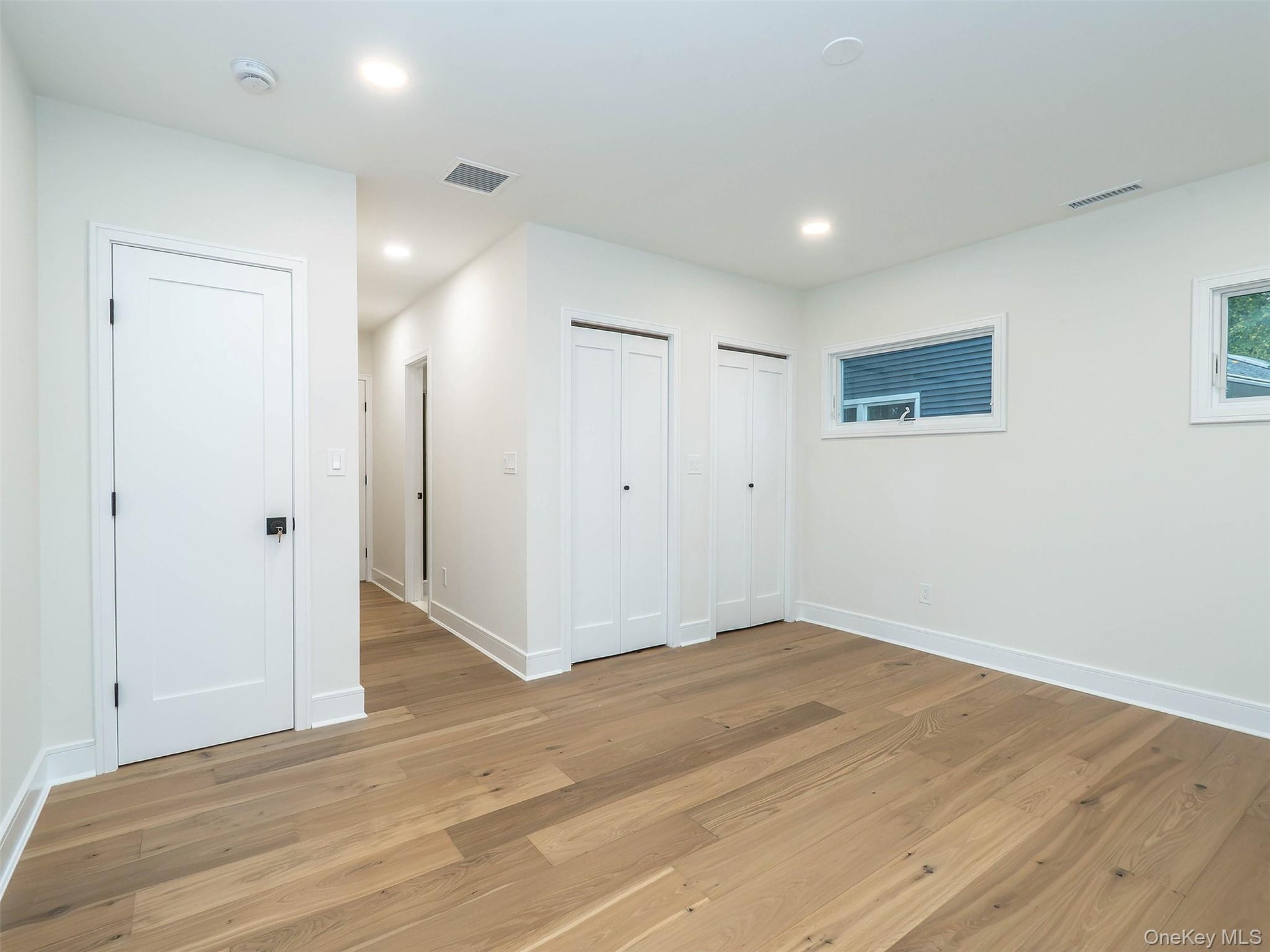 1st Floor: Primary bedroom (open door leads to en-suite bathroom)