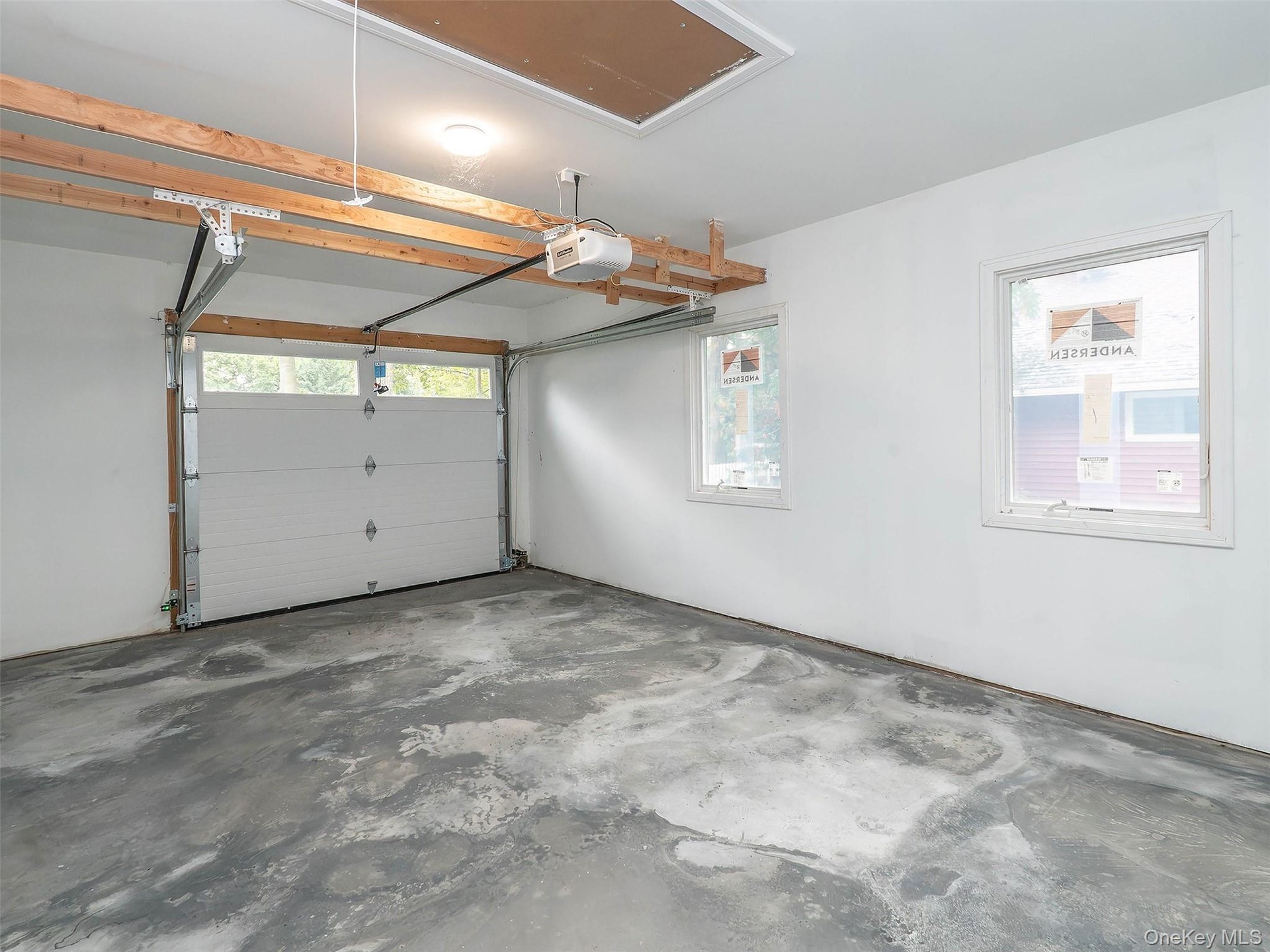 Poured concrete floor, pull down for attic and electrical box live here