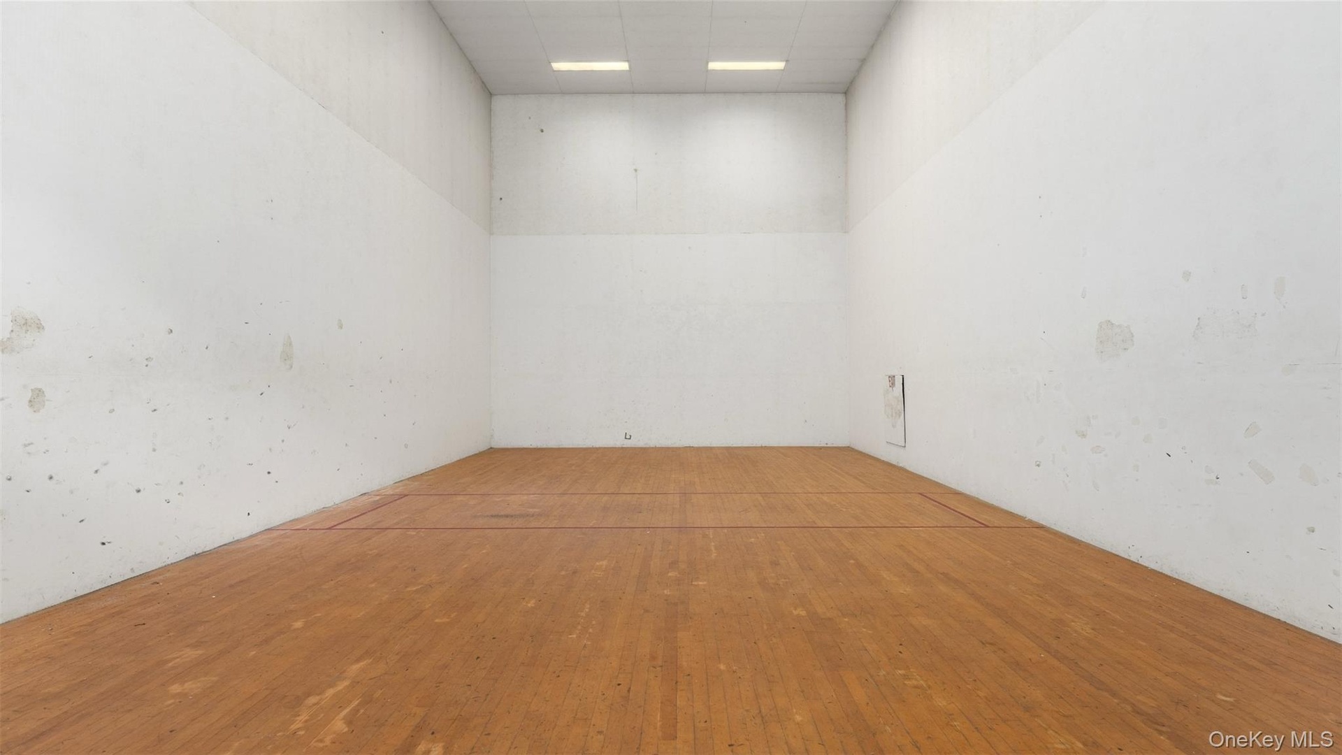 Racquet ball court in barn