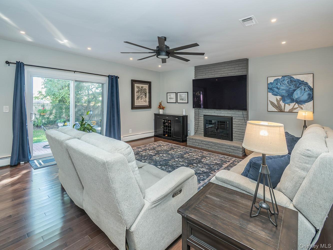 Family room/ Den with sliders to outdoor patio and yard