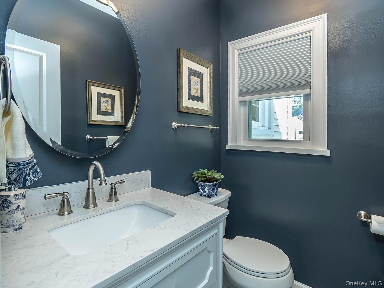 Half bath on first floor off of the family room/ den