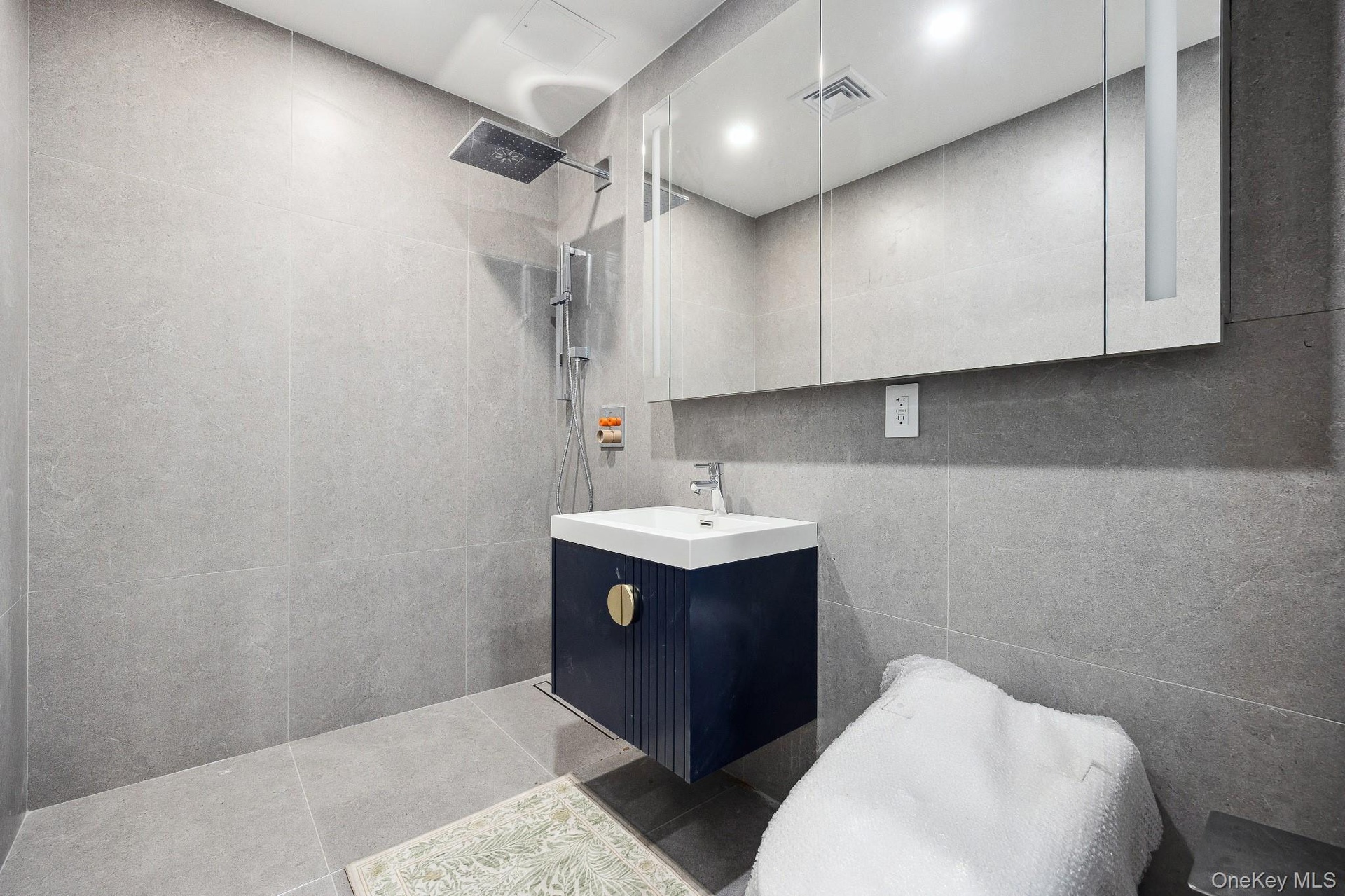 Full bath with walk in shower and vanity