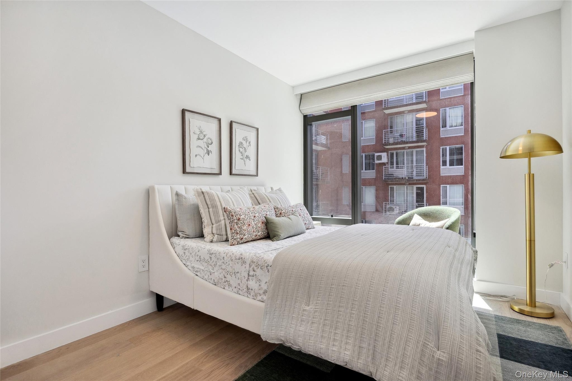 Bedroom featuring baseboards, wood finished floors, and floor to ceiling windows