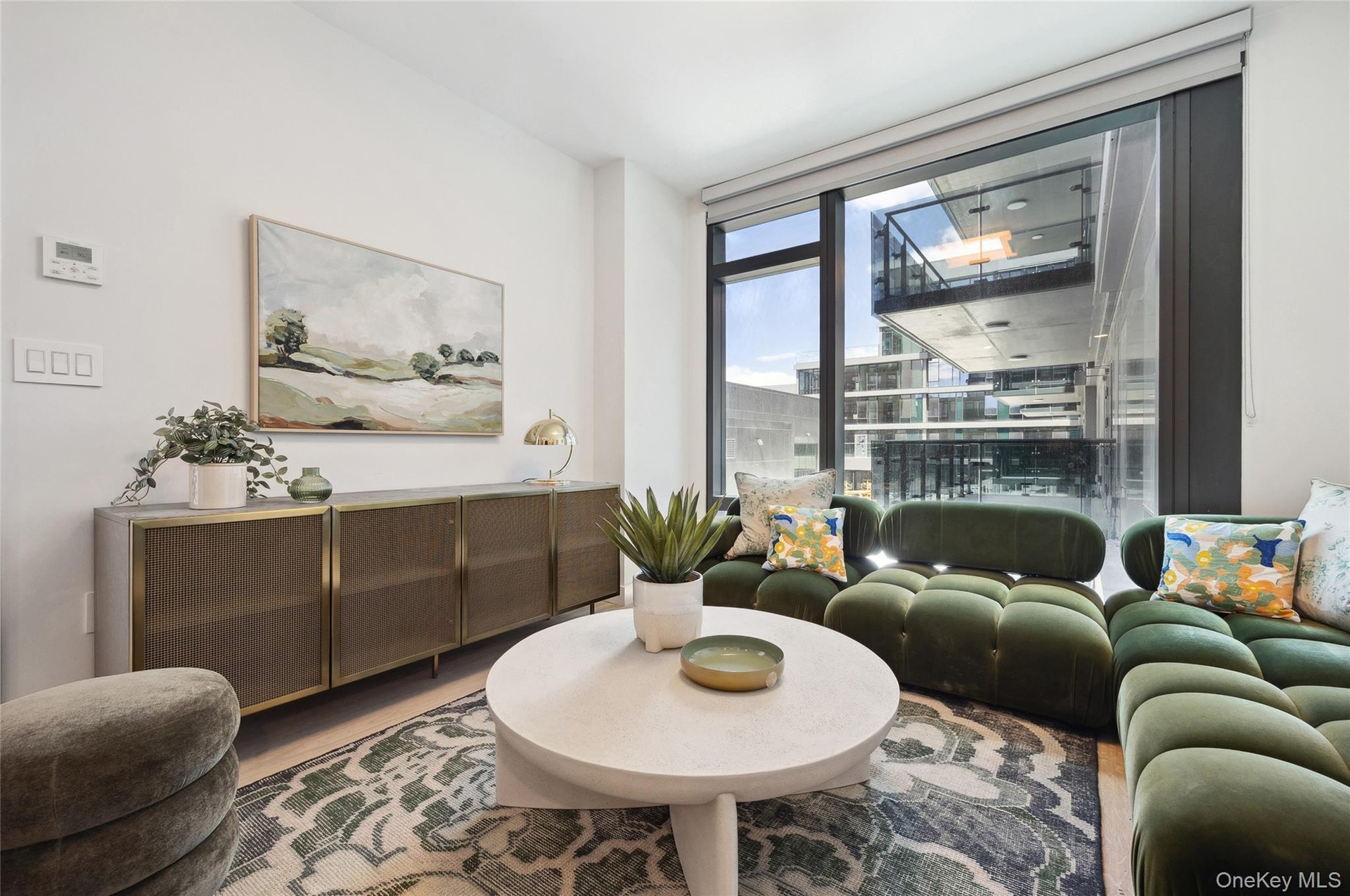 Living room with wood finished floors and floor to ceiling windows
