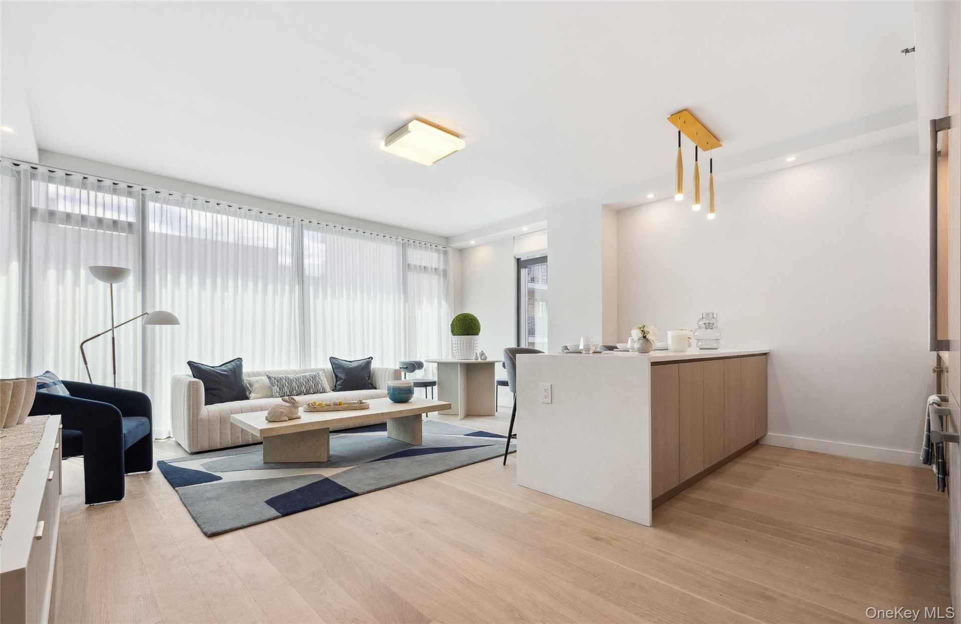 Living area featuring light wood-style floors and baseboards