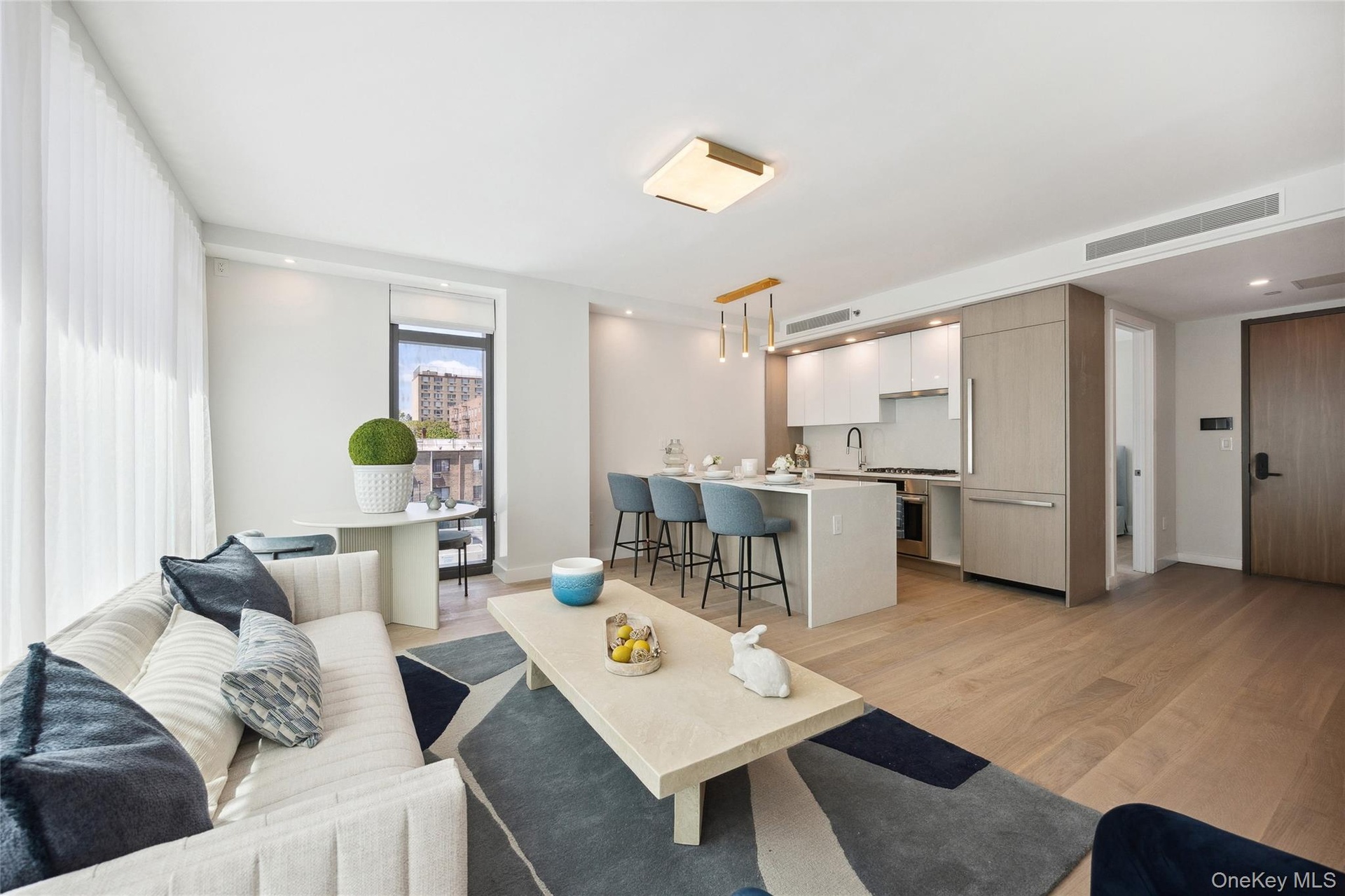 Living area with light wood finished floors and baseboards