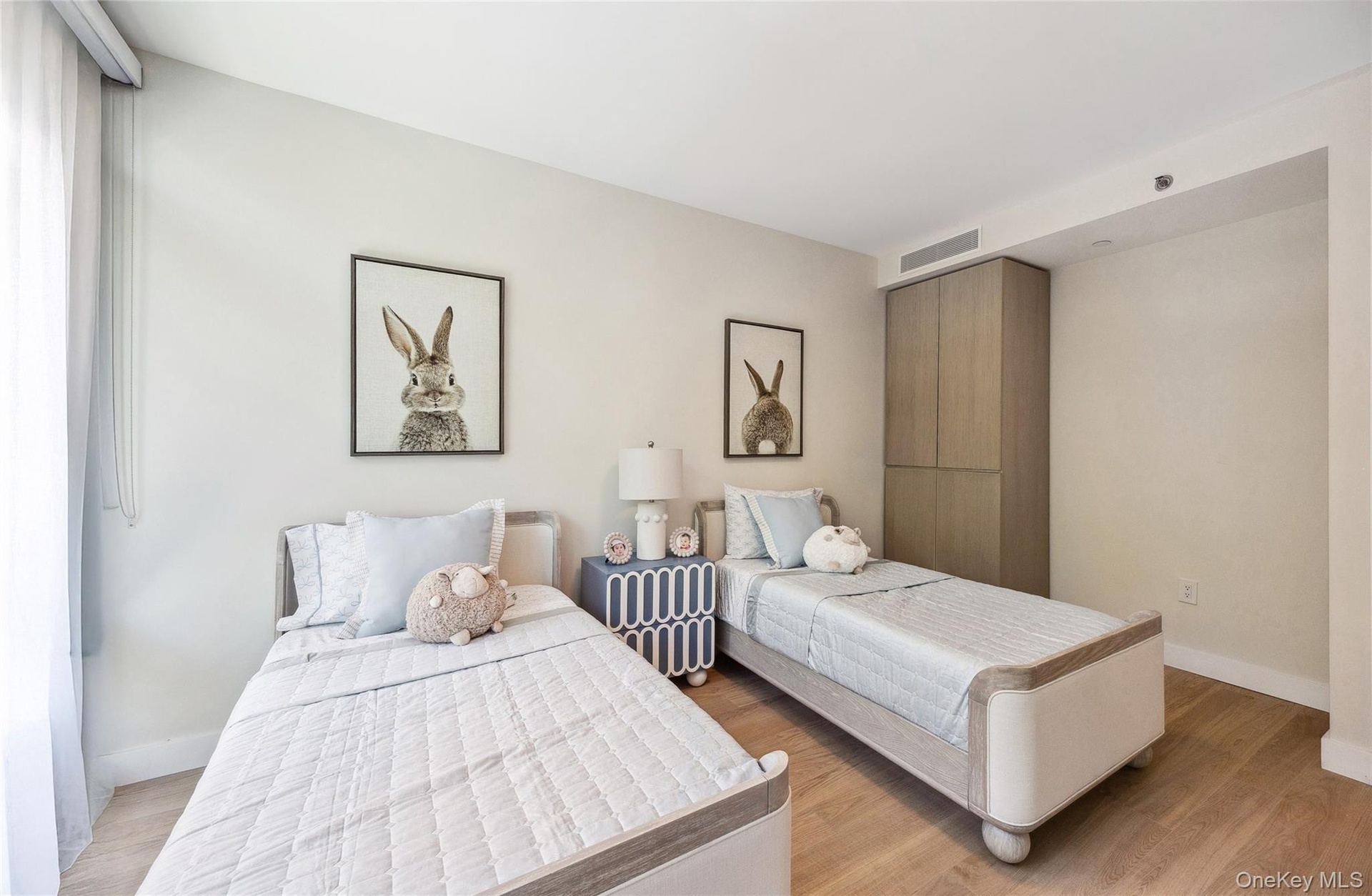 Bedroom featuring light wood-style floors and baseboards