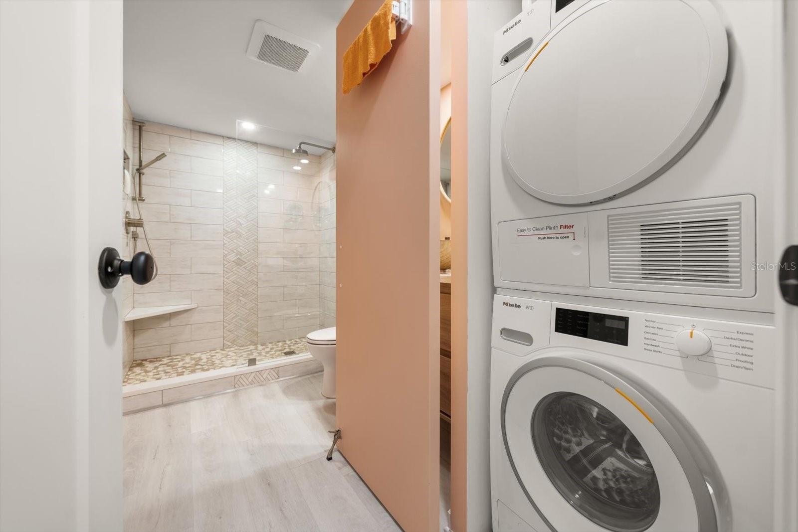 In unit Miele washing machine & dryer; discreetly tucked away in the guest bath.