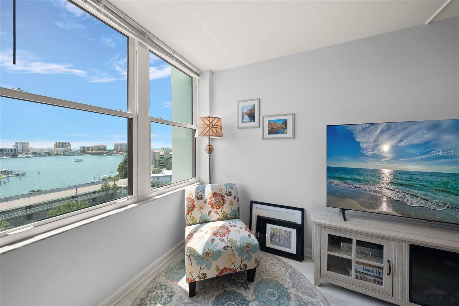Primary bedroom is a sanctuary with stunning water views.