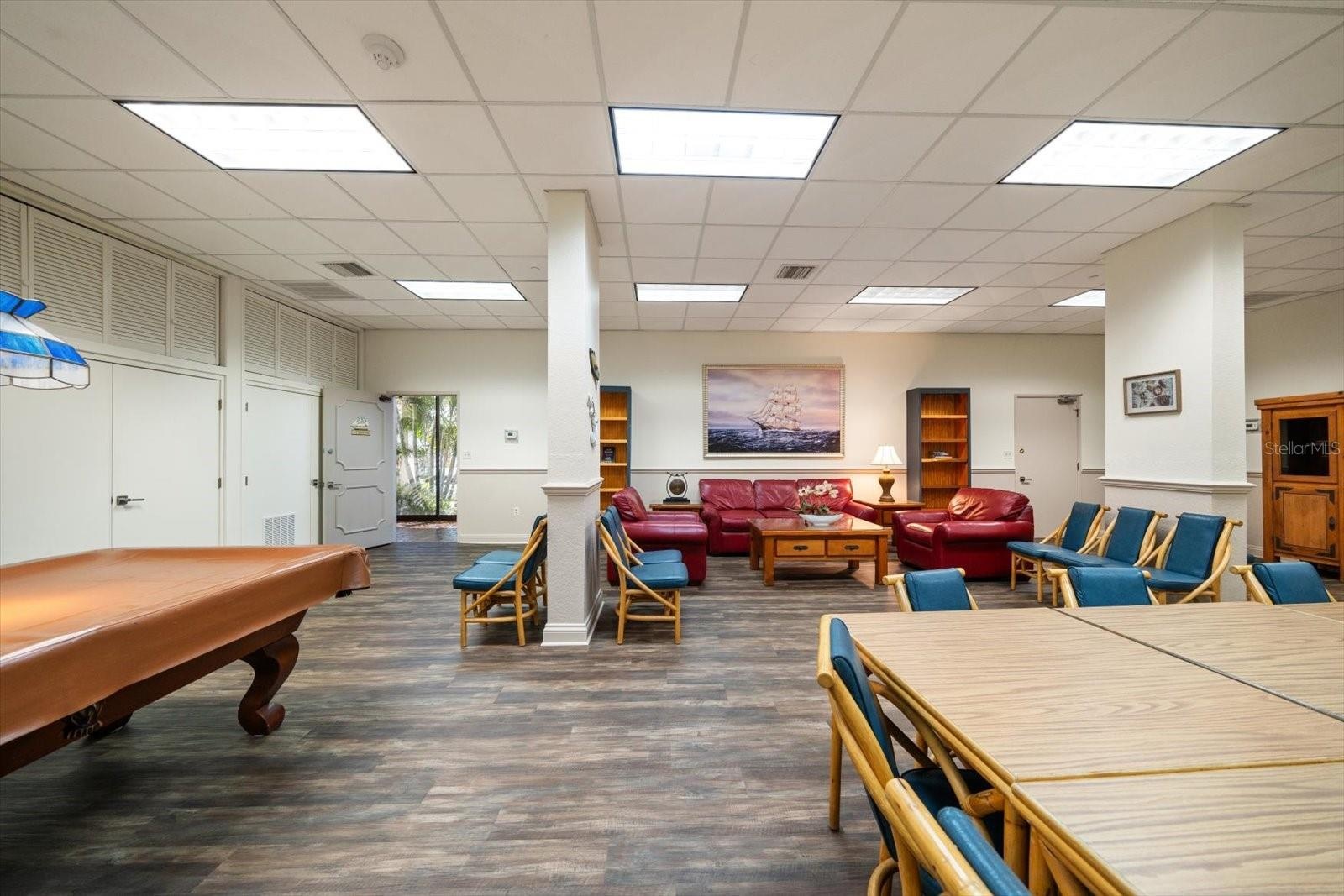 Community room featuring a kitchen, gathering space & billards.
