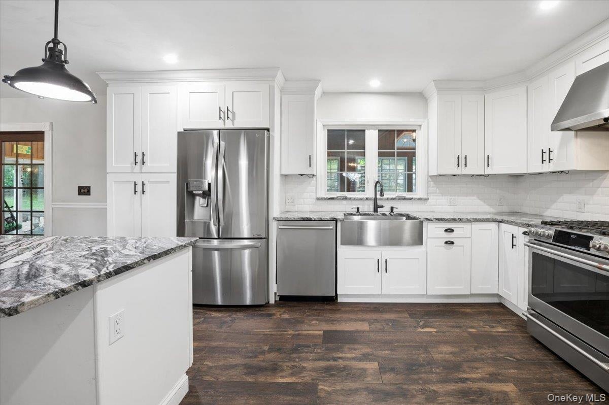Kitchen with stainless steel appliance.