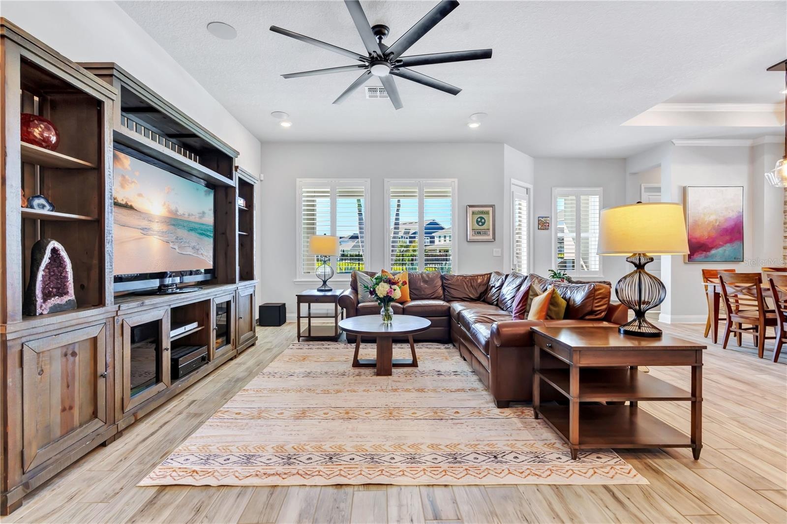 Family room with custom built in entertainment center and an easy connection to the kitchen and dining area.