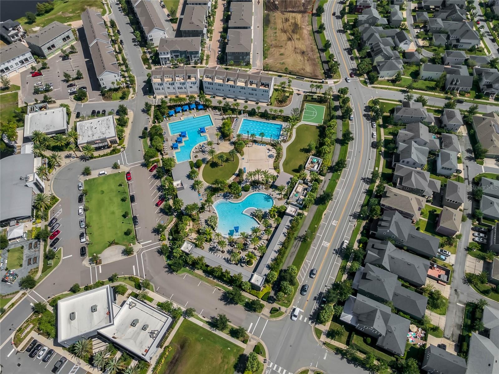Community pool complex surrounded by walkable neighborhood streets in Lake Nona.