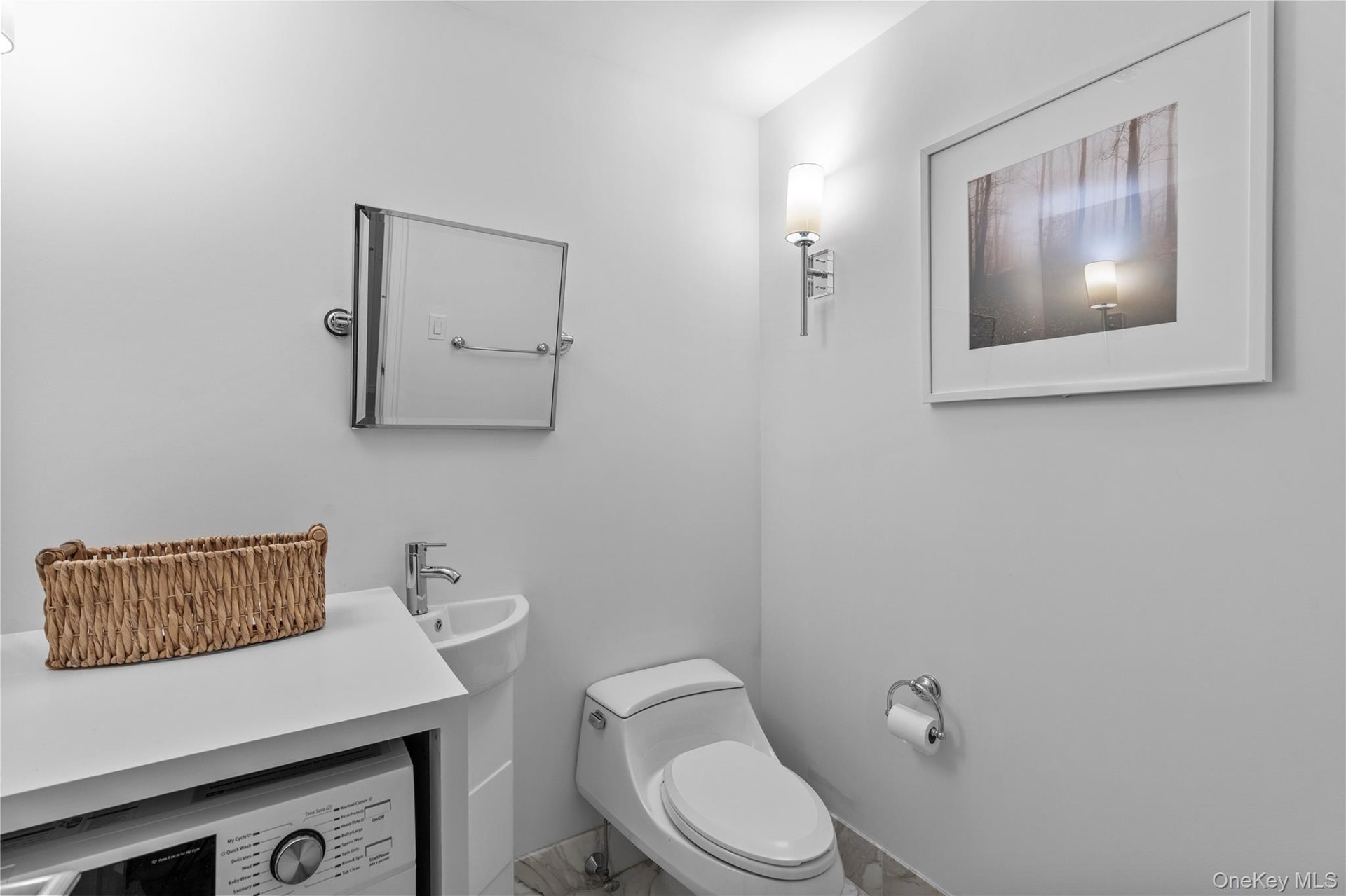 Bathroom with washer / dryer and toilet