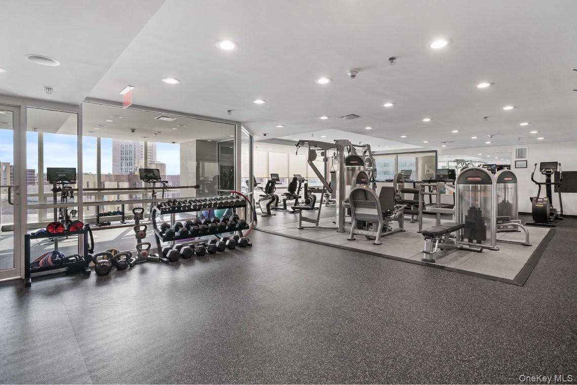 Exercise room featuring expansive windows and recessed lighting