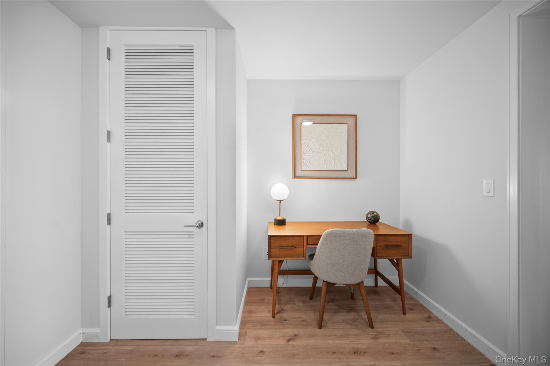 Home office with wood finished floors and baseboards