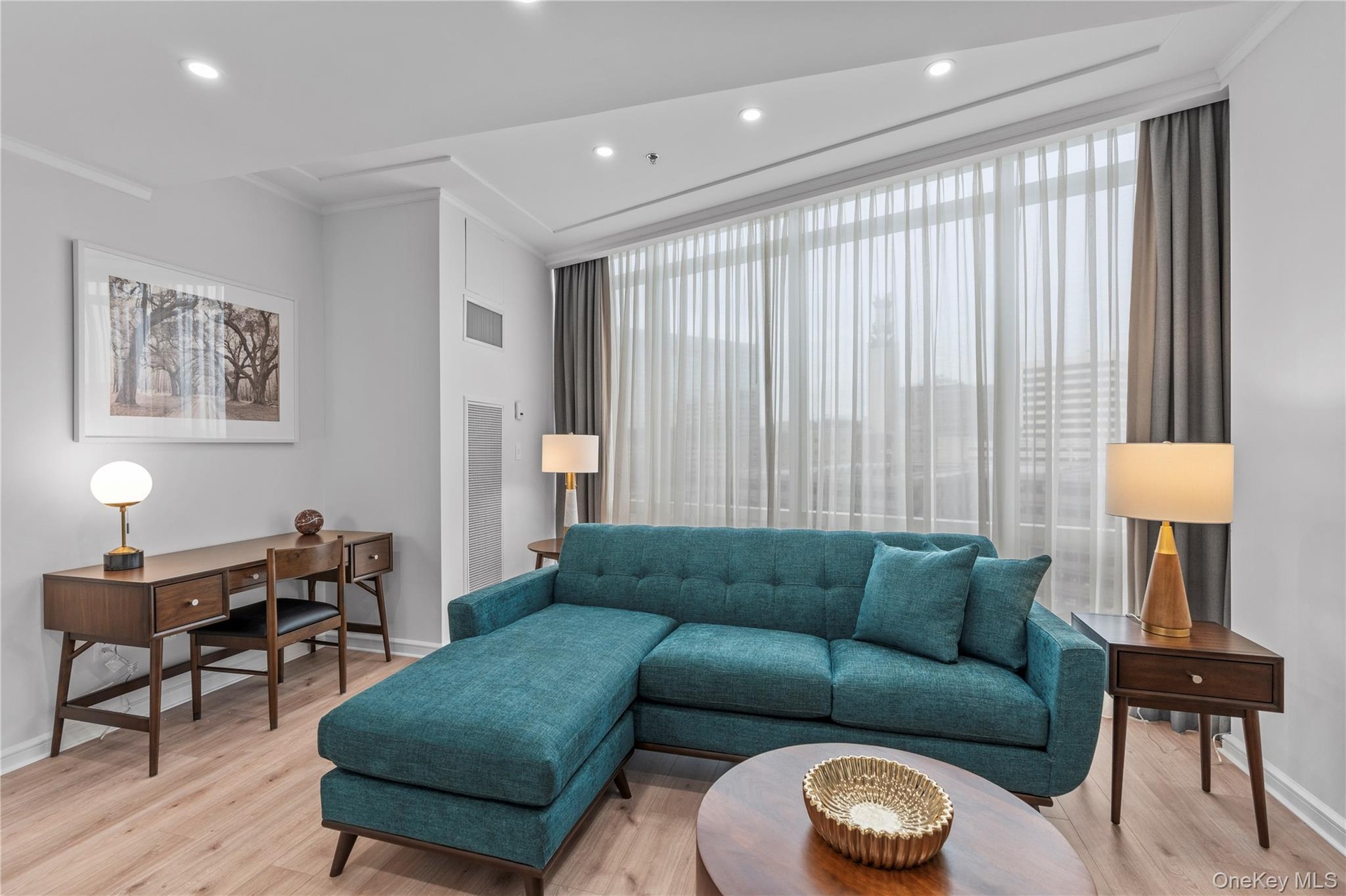 Living room featuring light wood-style floors, baseboards, visible vents, and recessed lighting