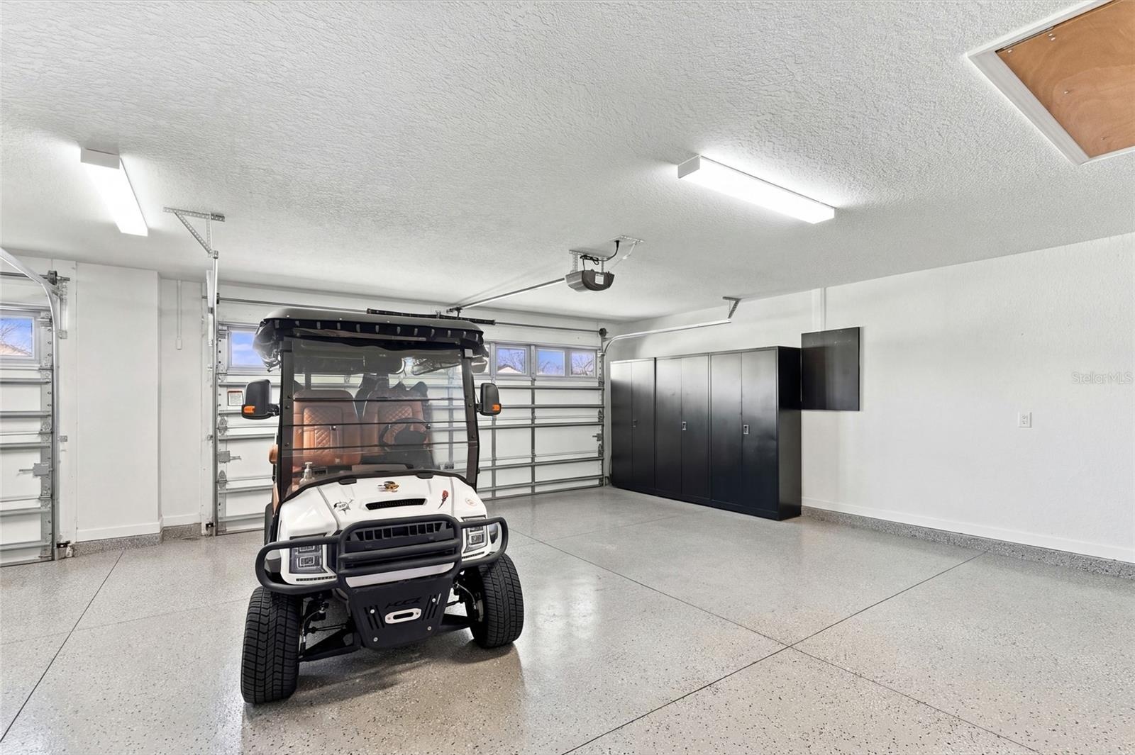 Garage's 2 Car area with a glimpse of Golf Cart side to left