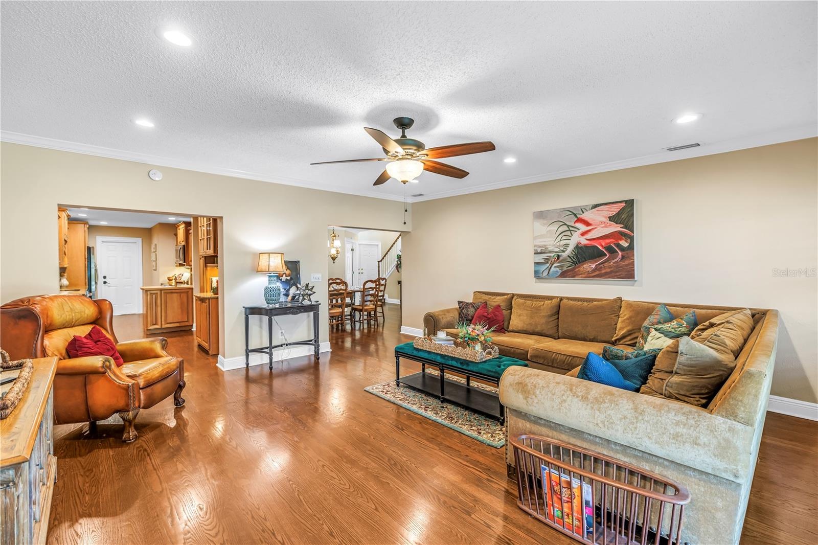 Spacious bonus family room (17x18) designed for effortless entertaining, featuring hurricane-rated sliders that offer seamless access to the screened 