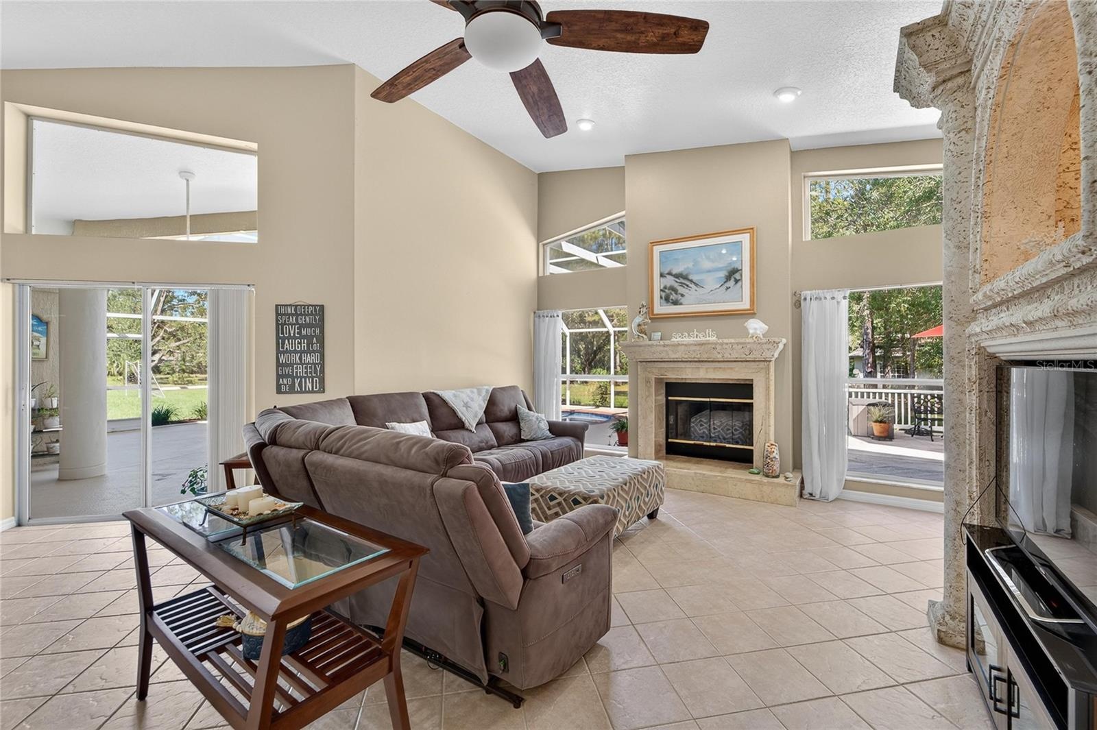 Family room is open to the kitchen, overlooks the pool and has a wood burning fireplace