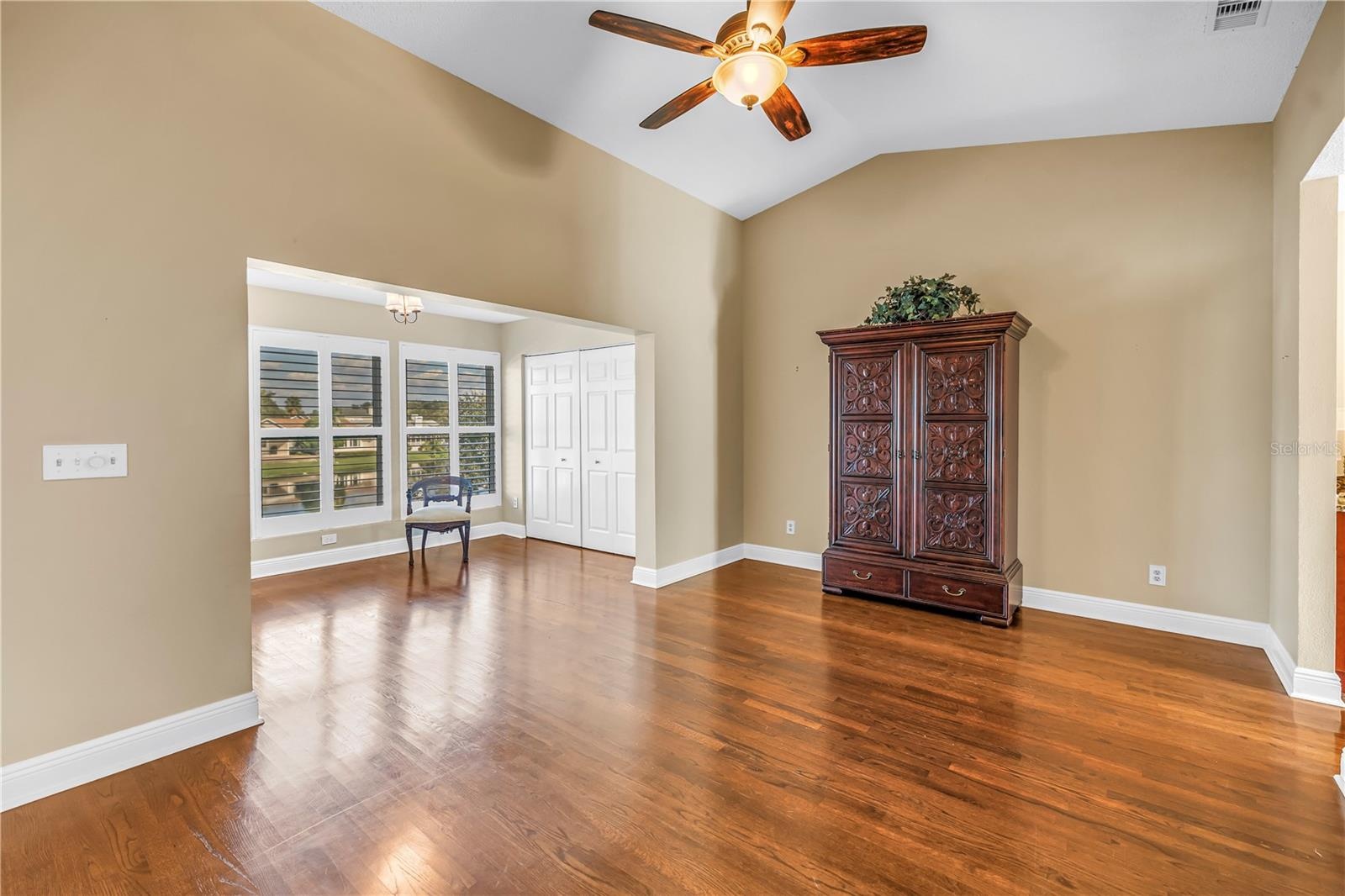 Spacious primary bedroom featuring vaulted ceilings and an elegantly enclosed porch with two additional closets. This room offers magnificent lake vie