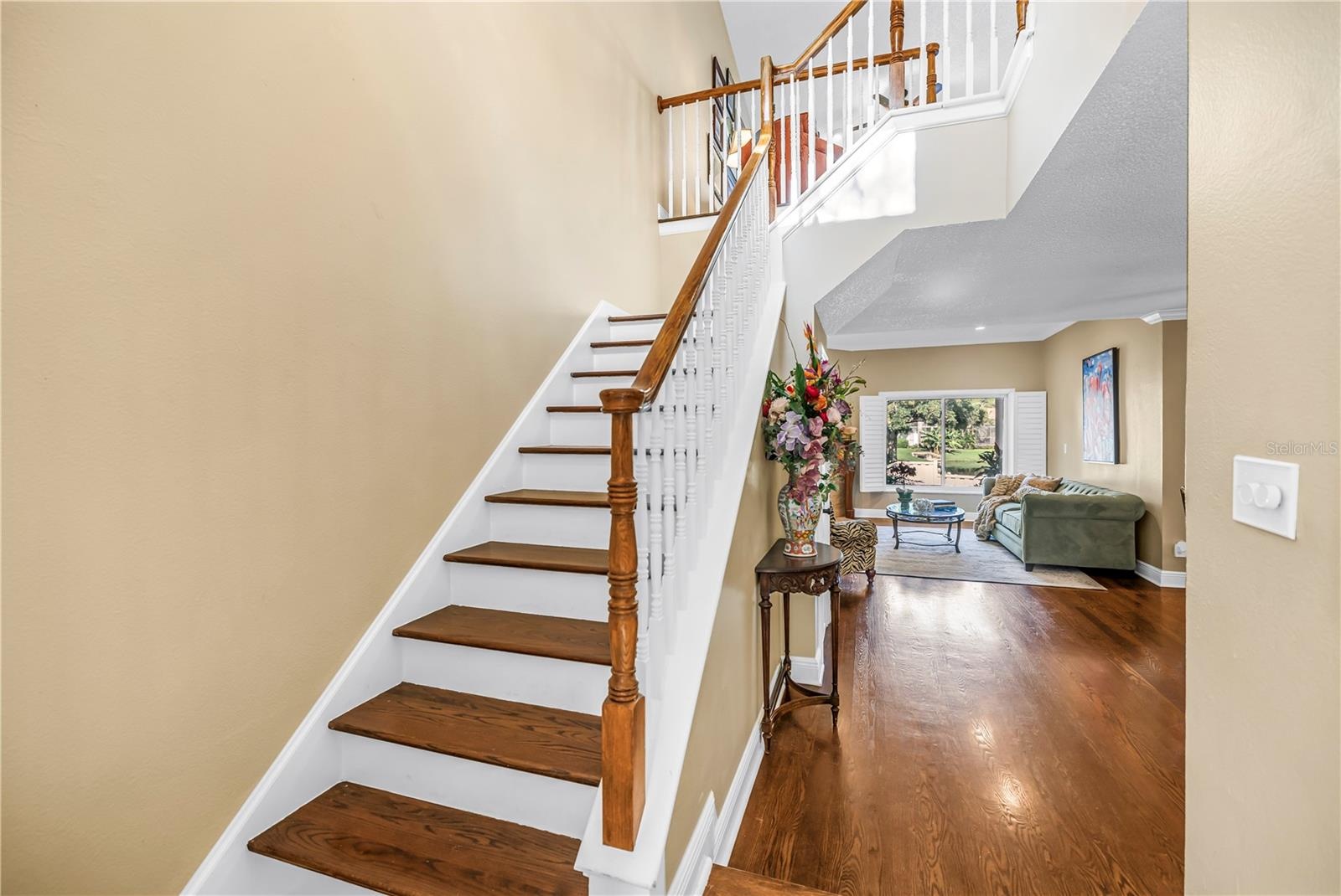 Exquisitely crafted hardwood stair treads complemented by solid-construction handrails.