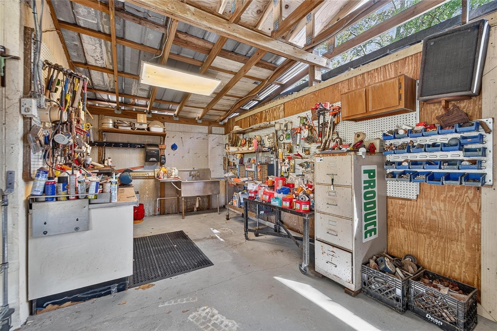 Shop/Barn has a sink  and cement floor
