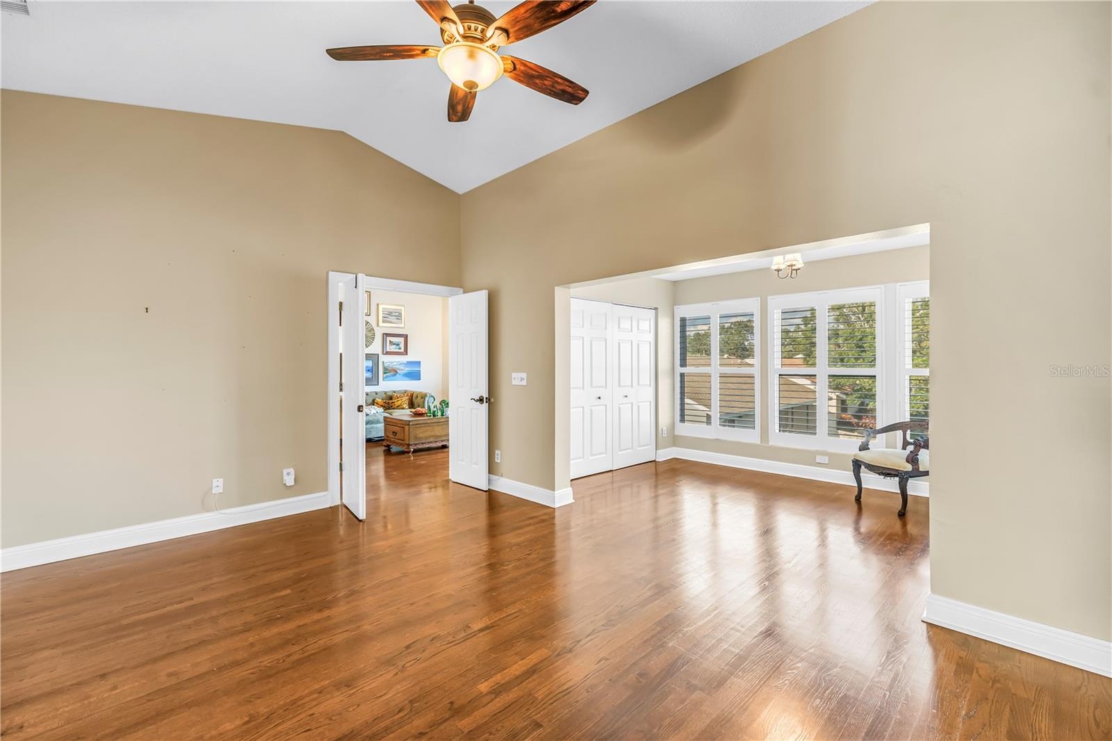 This secondary view showcases the primary suite and adjacent bonus area, highlighting the luxury French door entrance.