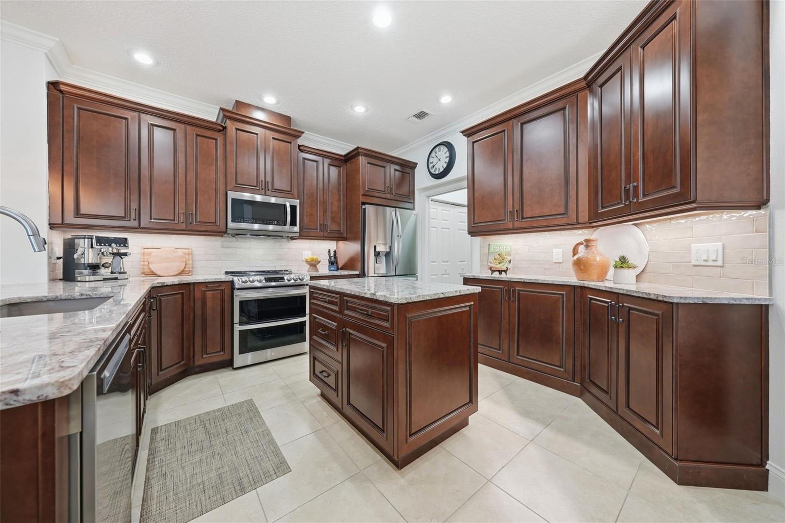 KITCHEN WITH CUSTOM SOLID WOOD CABINETS WITH PLENTY OF QUARTZ COUNTER SPACE