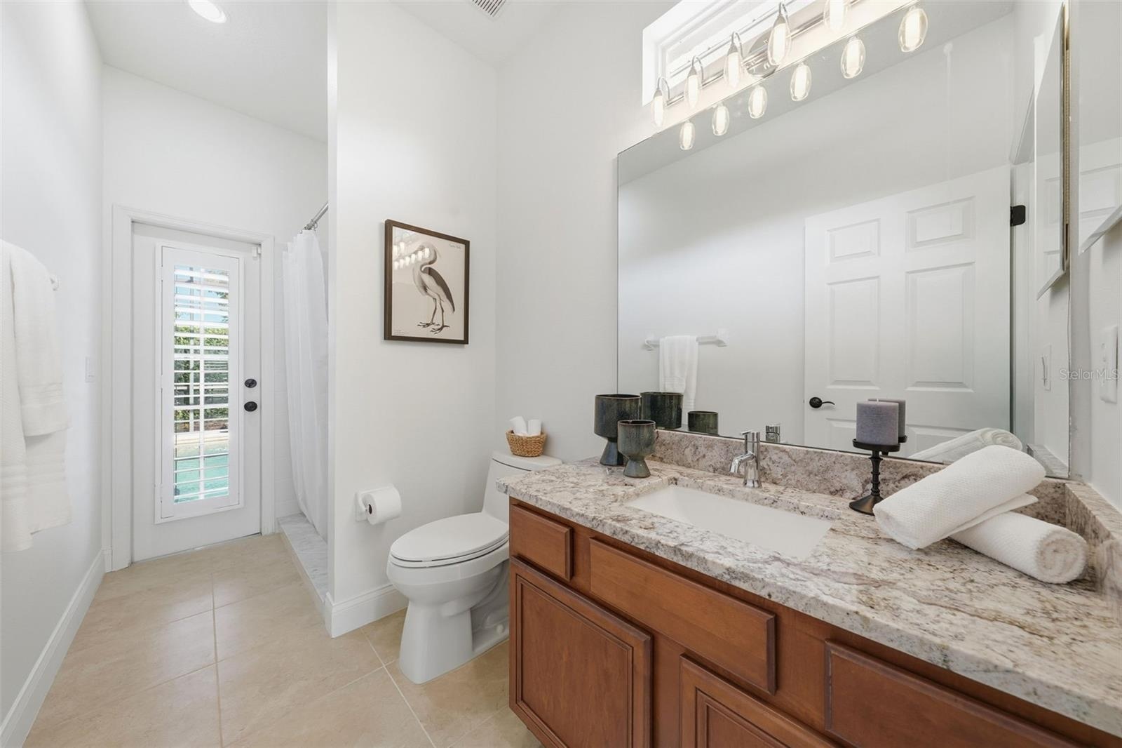 3RD BATHROOM (POOL BATH) WITH DOOR OUT TO THE POOL AND FULL SHOWER