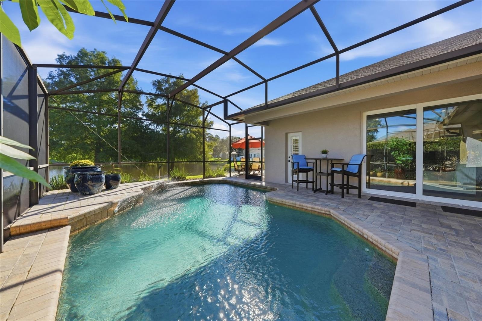 LOVELY POOL WITH PAVER COPING AND LANAI