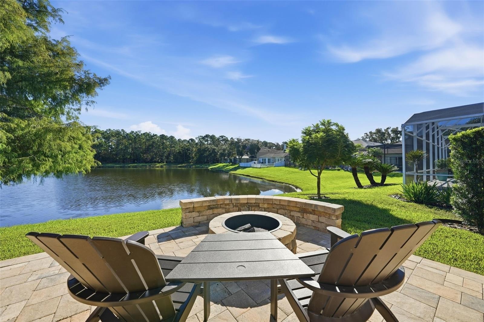 FIRE PIT ON THE PATIO OVER LOOKING THE POND WITH BUILT IN SEATING. LOOK AT THAT VIEW!